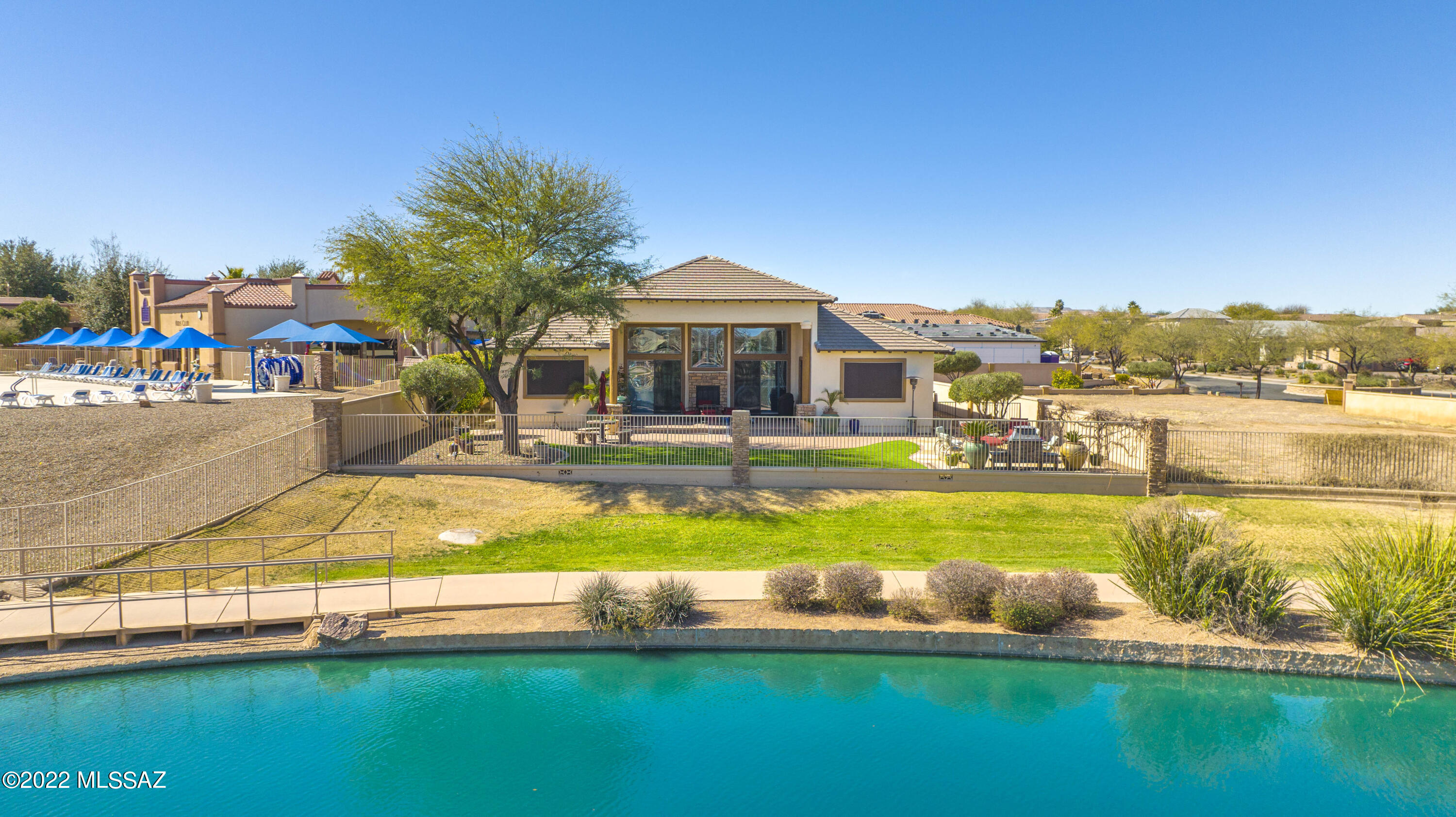 Rancho Sahuarita's Lakeside Master Piece 
how many lakes are in arizona? 128
And the Sahuarita Lake is one of them rarities here in the Sonoran desert. Desert living at its best , in a well crafted custom home ! This 4 bedroom, 4 bath home will check all of your boxes while captivating your heart with the tranquility of its surroundings. The home has cathedral ceilings in the main room, with an open & split floor plan, a see-through fire place nestled in a wall of windows over-looking the lake, custom kitchen cabinets made from Mesquite Wood & glass, granite counters, High End Appliances, under-counter lighting, Italian Porcelain Tile, All bathrooms have Mesquite Wood & granite to match the kitchen, Low-E Windows, over-sized 4-car garage w/ all LED lighting, built-in garage shelving&epox