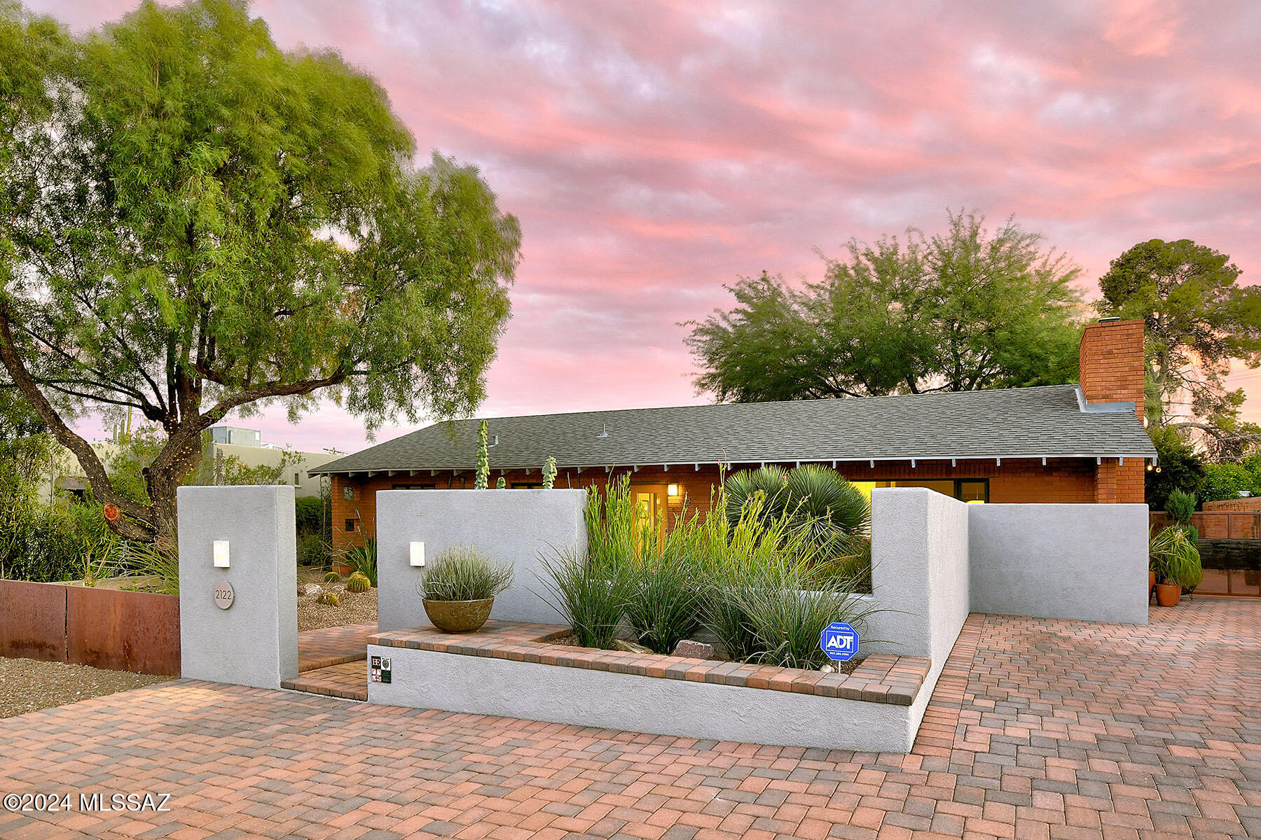This stunning 1950s double-brick home, nestled in the heart of the Arizona Inn/Blenman-Elm historic district, seamlessly marries timeless character with modern sophistication. Thoughtfully remodeled and upgraded, the home retains its historic charm while offering contemporary comforts, including a newer roof, Milgard dual-pane windows, and beautifully crafted integral colored concrete floors.
The chef's kitchen, designed for both functionality and style, boasts generous counter space, stainless steel appliances, a wine fridge, and a welcoming breakfast bar. The living room exudes warmth with its gas fireplace, while the adjoining formal dining area sets the stage for memorable gatherings. A private office provides a tranquil retreat for work or study. The primary bedroom features an ensuite bathroom and walk-in closet, complemented by a second bedroom and a tastefully updated bathroom. The family room, with its wall of windows, flows effortlessly into a lush backyard oasis. Beyond lies a fully equipped one-bedroom apartment with its own kitchen, laundry, bathroom, and patio, as well as an additional upstairs studio apartment, offering versatility and privacy for guests or extended family.
Outdoor living is elevated with a ramada perfect for entertaining, complete with a BBQ area and a movie screen, all set beneath the canopy of a large mesquite tree. The backyard, adorned with brick pavers, invites relaxation and gatherings in equal measure.
Practicality meets charm with a two-car garage, and as part of the National Historic Register, the home qualifies for a 35-45% property tax credit for owner-occupants. Ideally situated, it's just a short stroll to Banner Hospital, the University of Arizona, the Modern Streetcar, restaurants, parks, and more. One owner is a licensed Real Estate Broker in AZ.