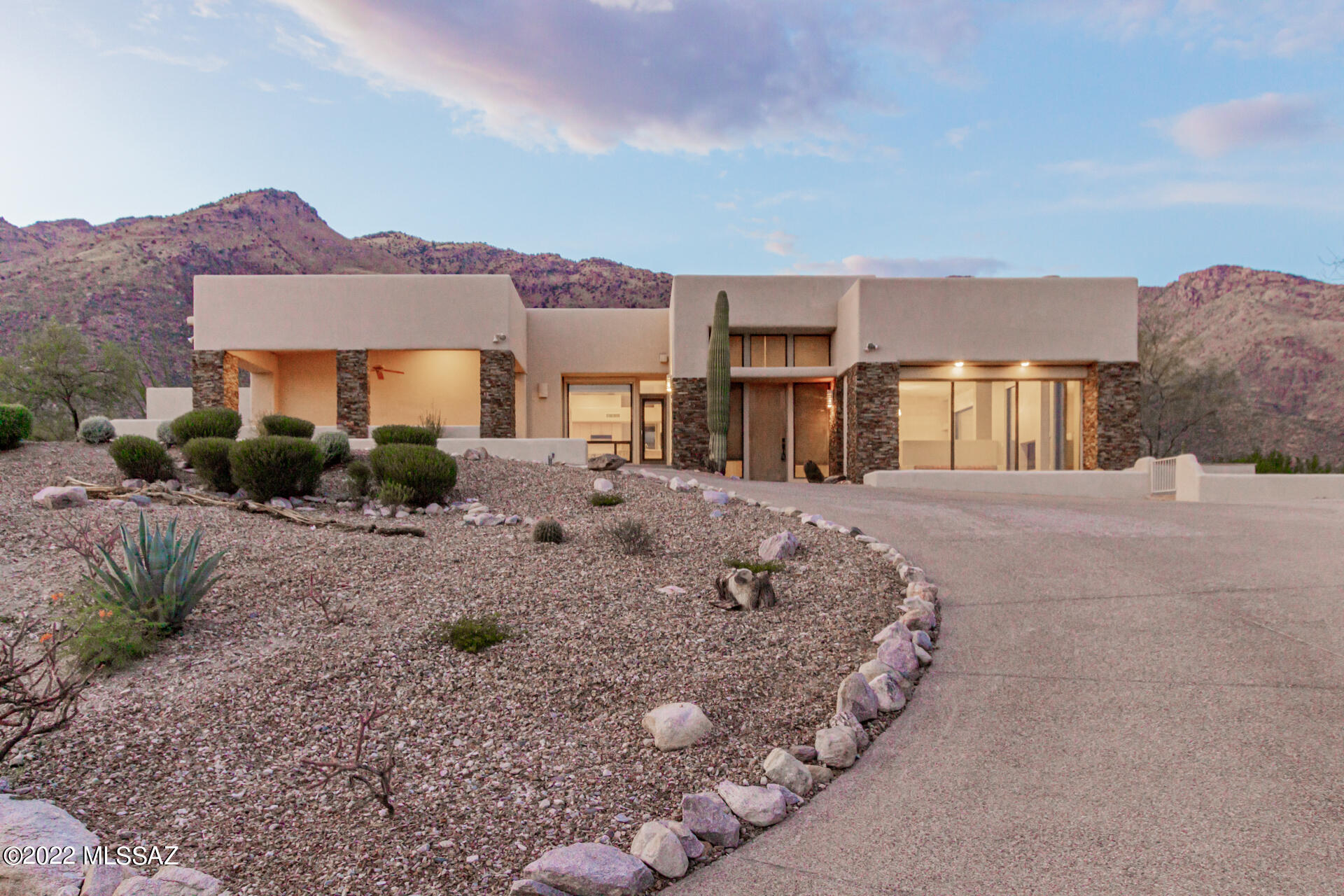 Spectacularly situated on a high lot to maximize both city and mountain views, this home will not disappoint.  Enjoy the twinkling city lights from the front covered patio, a dip in the negative edge pool to cool off from the summer heat or a glass of wine from the high perch of the elevated rear patio next to the outdoor fireplace.  This home is designed to enjoy the one of a kind lot & Tucson indoor/outdoor lifestyle.  Inside you will find large, grand windows that showcase the views, a versatile floor plan with updated master bath, multiple living areas, a bonus space that has been used as a home gym, two guest rooms with a connected/shared bathroom, spacious kitchen with easy flow to the family room and more formal living space and more.  Tons of storage in 2 car garage + 3rd detached.