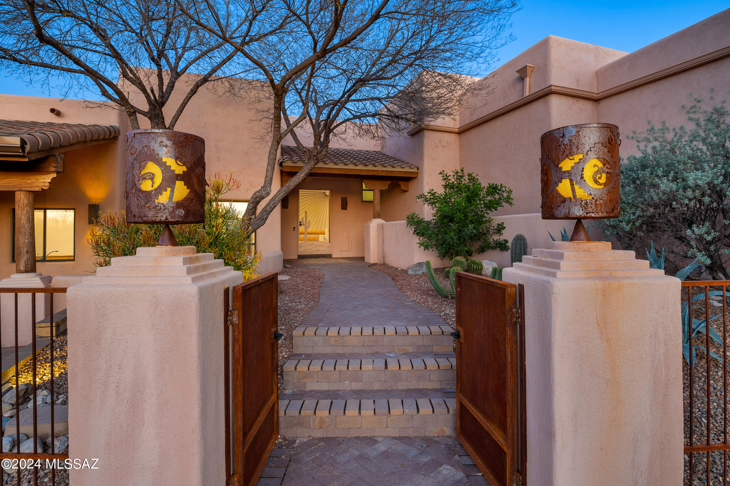 Panoramic Catalina Mountain views from this exceptional custom home on an elevated 3.6-acre homesite in gated Wild Horse Ranch Estates. Privacy & seclusion coupled w/ convenience & access provides the best of desert living. A long driveway leads to this magnificent home built to capture picturesque views of the mountains, sunrises & sunsets. Upon entry, Rincon Mountain views are framed by a large wall of windows in the living room w/ a fireplace & a separate patio. Spacious formal dining room for hosting dinner parties & holiday gatherings. Center island w/ breakfast bar in the kitchen opens to the great room w/ soaring wood-beamed ceilings & massive windows that stream in natural light & capture breathtaking mountain views.