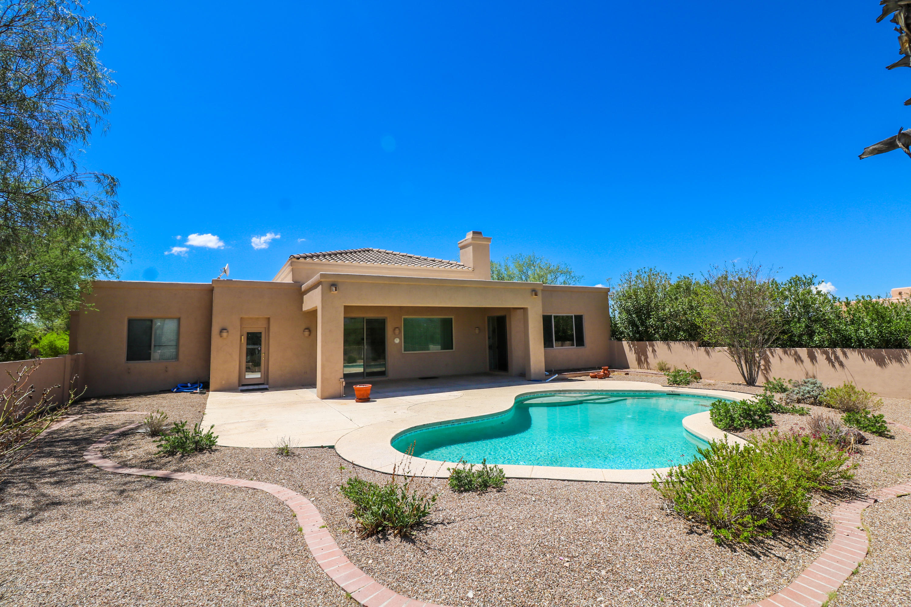 4 bed, 3 bath home in quiet subdivision on .83 acres. This home has a open floor plan, high ceilings, lots of windows and natural light that show case the amazing views of the catalina mountains. The master bedroom has two large closets, and private access to the patio/backyard through a sliding glass door. The patio and pool face the Catalina Mountains with a gorgeous view. The large 3 car garage provides plenty of storage. Must see!