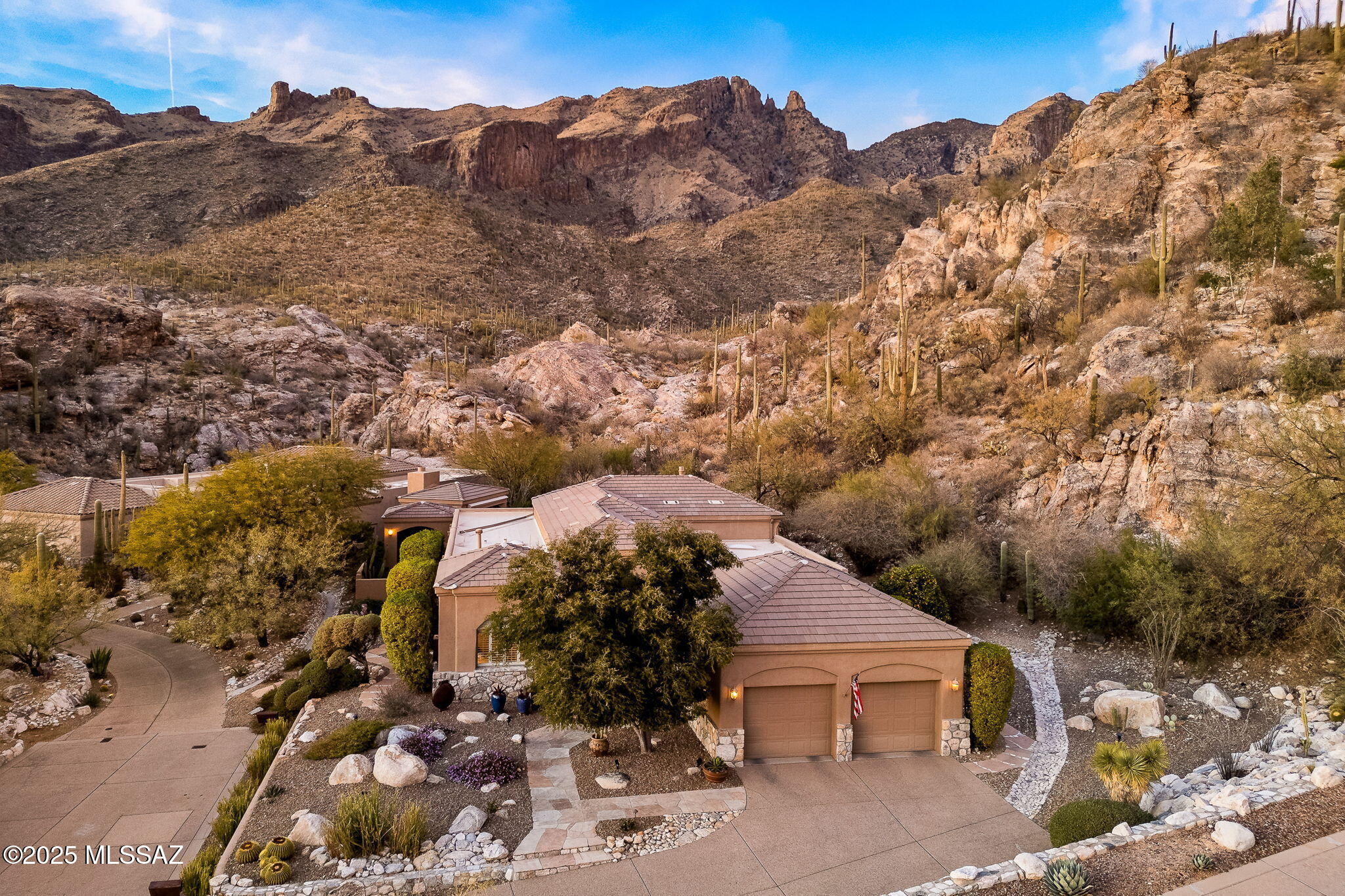 *4087 E PLAYA DE CORONADO* Situated on a Rare, Prime Foothills lot backing up to the Coronado National Forest, this stunning 3-bedroom, 3-bath home offers luxury downsizing without sacrificing location, views, or finishes. Nestled in the Exclusive Gated Enclave, The Summit at Finger Rock, this One-Owner home provides panoramic views of the majestic Catalina Mountains, with Finger Rock as the centerpiece. The captivating natural landscape includes towering rock outcroppings, saguaro-covered hillsides, abundant wildlife including big horn sheep, white tail deer, bobcats, countless species of birds and dramatic vistas in every direction. As if that weren't enough, you'll enjoy direct access to endless hiking trails such as Finger Rock & Pontatoc Ridge right in your own million-acre backyard. Built by a retired Air Force General and his wife, this home was crafted with an emphasis on luxury, low maintenance, and seasonal living. It embodies the essence of the sought after Tucson lifestyle, blending comfort, style, and function. From the moment you arrive, you'll appreciate the quality and attention to detail that has been maintained to the highest standard. Soaring ceilings and walls of windows create a bright, airy atmosphere, while the open floor plan and expansive flagstone-covered patios offer the perfect space for entertaining. The outdoor living area is an oasis, featuring two water features, an outdoor grill, and a large private ramada with a gas fireplace, sitting area, and al'fresco dining spaceideal for hosting friends or enjoying quiet moments with nature. Inside, the gourmet kitchen boasts newer stainless-steel appliances, granite countertops, custom cabinetry, a spacious pantry, and a butcher block island, making it perfect for culinary enthusiasts. Built with accessibility in mind, this home offers wide doorways, zero-clearance thresholds, a walk-in shower, and NO steps, a rare find this high up in the Foothills! Steel-frame construction ensures durability and peace of mind, while the concrete tile roof and native desert landscaping make this a low-maintenance haven. The heated and cooled storage room off the garage would make an ideal wine cellar, studio or home office. Whether you're seeking a full-time residence or a "lock-and-leave" seasonal getaway, this home is the perfect retreat in an idyllic location. Offered for the first time in 24 years, this exceptional home is an opportunity not to be missed. Homes of this caliber, in such an extraordinary setting, are rarely available and are typically priced well over $3,000,000. Don't miss your chance at owning such a special and unique Tucson Foothills property.