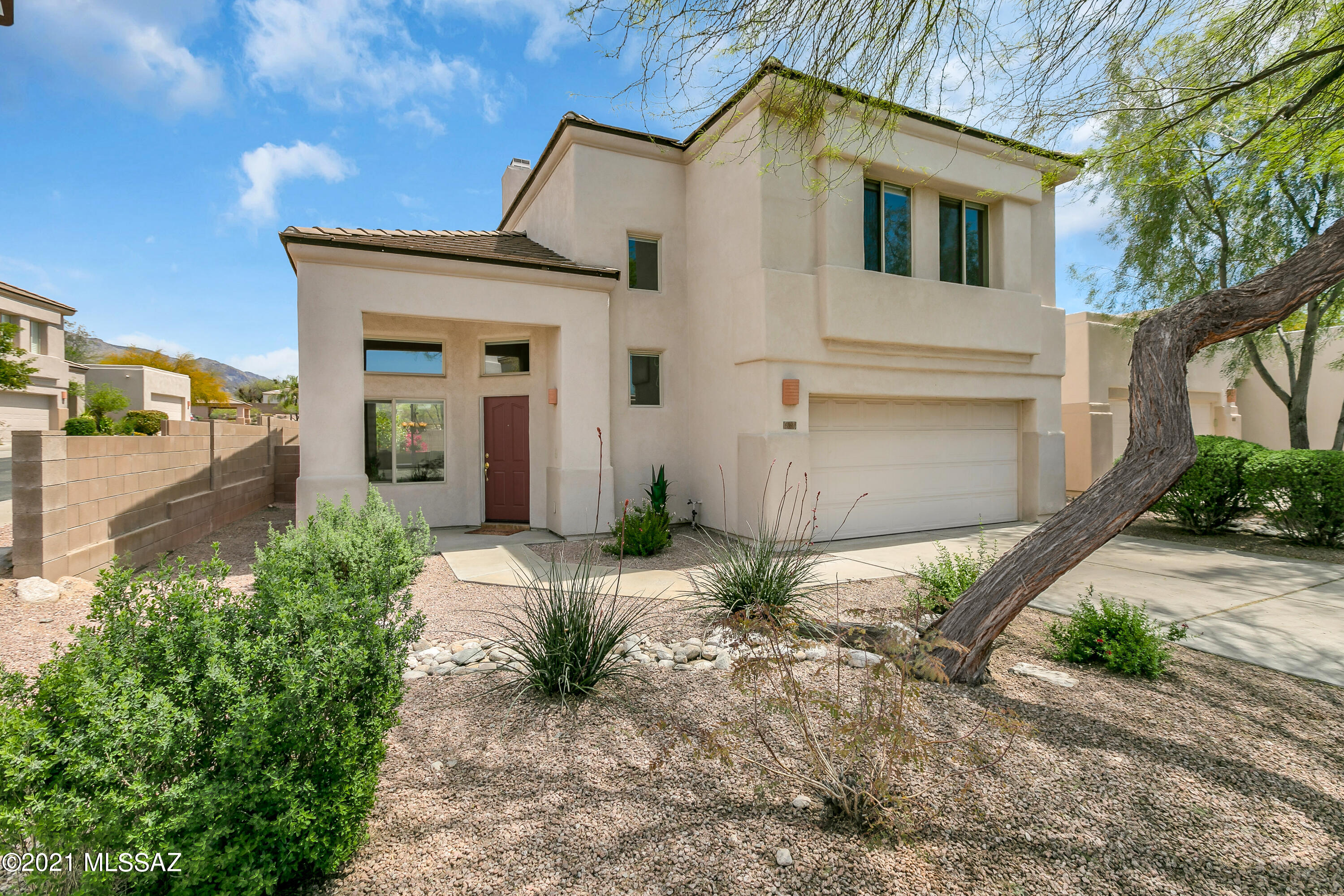 Beautiful contemporary AF Sterling home in highly desirable neighborhood on corner lot with 4 BR/2,5 BA. Light and airy with high ceilings, easy open floor plan and cozy gas fireplace. Large, newer kitchen with Corian counter tops. Mountain views from living room, family room, kitchen, master bed/bathroom and balcony off the master suite. Delightful covered back patio with citrus trees, bougainvillea, desert plantings and more mountain views. Lovely community pool nearby. Freshly painted interior and new water heater, carpet, gas range, toilets and epoxy coated garage floor and newer HVAC. Quiet yet close to shopping, restaurants and easy drive to UofA, Banner and downtown. Move-in ready.