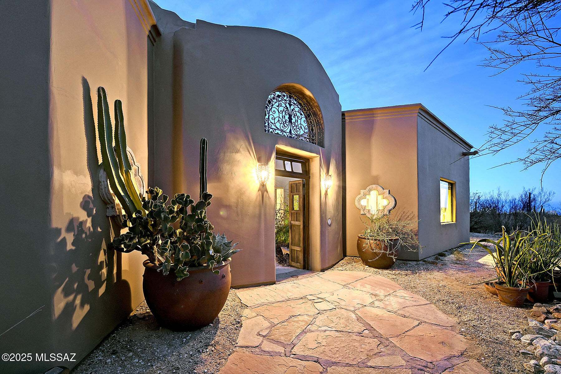 Exquisite Sonoran Desert Retreat - A One-of-a-Kind Masterpiece.
Discover the enchanting beauty of Rancho Cielo, a custom-designed 2,783 sq. ft. architectural gem nestled on 3.31 acres of serene desert landscape, with stunning rock work, in northwest Tucson. This exceptional three-bedroom, two-bath home is a true work of art, featuring hand-troweled Venetian plaster interiors, soaring 14-foot ceilings, and expansive picture windows framing breathtaking 180-degree views of the Santa Catalina Mountains.
Every detail of this residence exudes craftsmanship and elegance. The open-concept design seamlessly blends indoor and outdoor living, highlighted by custom Knotty Alder cabinetry, Mesquite doors, and high-end kitchen appliances. A spacious office/den, a library with built-in shelving and an adjacent wet bar and a potential 85-square-foot wine cellar offer both functionality and refinement.
Step outside through two sets of French doors opening onto a spectacular view of the Santa Catalina Mountains and a 65-foot resort-like back porch; framed by six hand-carved 9-foot Cantera stone columns, imported from Guadalajara, Mexico. The 515 sq. ft. primary suite is a true sanctuary, with 11-foot ceilings, a spa-like Jacuzzi tub with a mountain view, and a generous walk-in closet.
Throughout the home, elegant architectural finishes and archways draw inspiration from India, Morocco, and Mexico, lending a sense of worldly sophistication. Uniquely designed 'in-the-round', the residence flows effortlessly into a private 30-foot circular Moroccan garden, centered around a Bali-inspired water fountain and surrounded by mature fig and pomegranate trees.
This estate is adorned with two stunning hand-crafted cupola domes, an outdoor shower tucked between bamboo and pomegranates, and an intimate interior courtyard offering nine floor-to-ceiling window views from nearly every room. The entryway welcomes guests with a striking nine-foot antique Mesquite door, opening into a lush, botanical haven.
For those who cherish sustainability, 32 solar panels power the home, complemented by R-44 insulated walls, R-55 insulated ceilings, a Trane 21.5 SEER air conditioning system, and an 89 gallon hot water heater augmented by a second solar hot water heater, resulting in energy efficiency reminiscent of the 1950s. A 5,000-gallon water storage tank ensures an ample supply of sweet, pristine well water from a private two-family well.
Outdoor enthusiasts will delight in the stargazing and yoga deck, offering panoramic views of city lights, the Santa Catalina and Tortolita Mountains, and Kitt Peak National Observatory. Additional outdoor features include a south-facing garden patio and a classic free-standing stone ramada, perfect for entertaining.
This extraordinary home sits a short walk from the La Cañada Wash, a gateway to hiking trails in the Tortolita Mountains, where deer, javelina, and rabbits roam freely. The property's deed allows for an 1,252 sq. ft. guest house, providing an incredible opportunity to expand upon this private desert sanctuary.
All of this, just 25 minutes from downtown Tucson and the university district, a truly rare find in the Sonoran Desert.