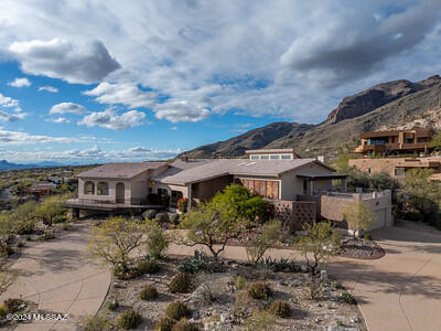 Featuring a Grand Foothills Estate that soars above the Catalinas Mountains! This southwestern open concept boasts windows galore, cathedral ceilings centered around a majestic great room. Extraordinary 360-degree views of the Catalinas, Ricon, Santa Rita and Tucson Mountain chains with unobstructed city lights. Bask in privacy on a stylish composite wrap around deck as you gaze upon the whole Tucson Basin, Mexico and beyond. Enjoy cooking in this newly remodeled kitchen with features of quartz countertops, horizontal book-matched grain walnut cabinets and designer appliances that look upon Finger Rock. This home has it all, location, cultural attractions, foothills resorts and golf country clubs along with many hiking trails of surrounding wilderness.