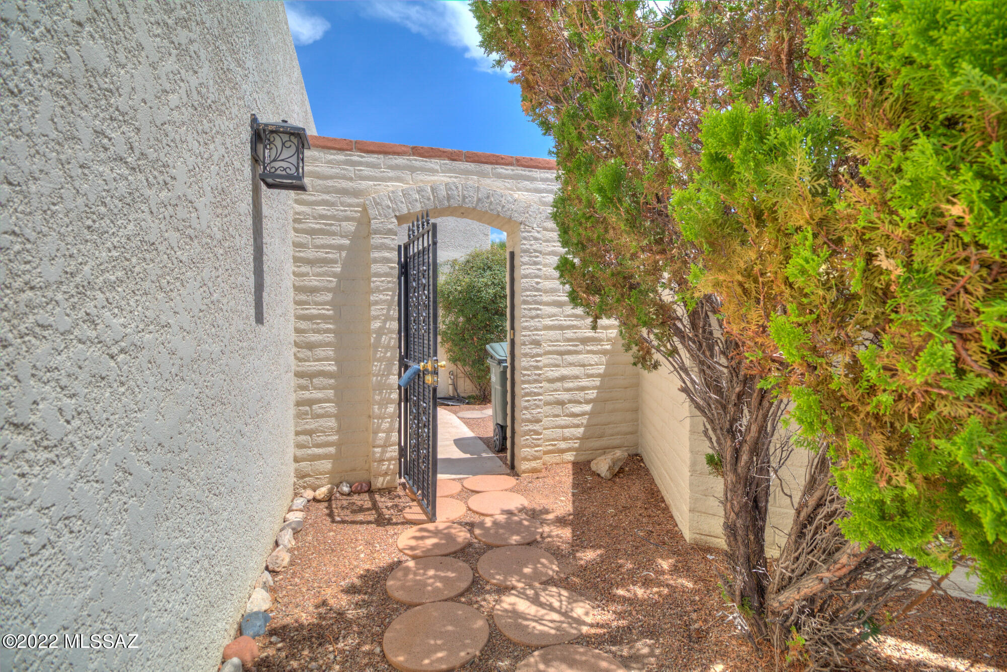 This is it!  This 3bd/2ba Townhouse will not disappoint.  Tile throughout and large great room with a sliding door to enjoy the beautiful mountain views from inside or on one of the patios. The large kitchen is spacious with lots of cabinets and a window over the sink. The large primary bedroom has sliding door that leads to a large patio area and yard.  Plenty of storage area in the 2-car garage too. Feel safe and secure with the security door and front gate.   Take a dip at the community pool on the hot summer days. This community does allow long term rentals.  Welcome Home.