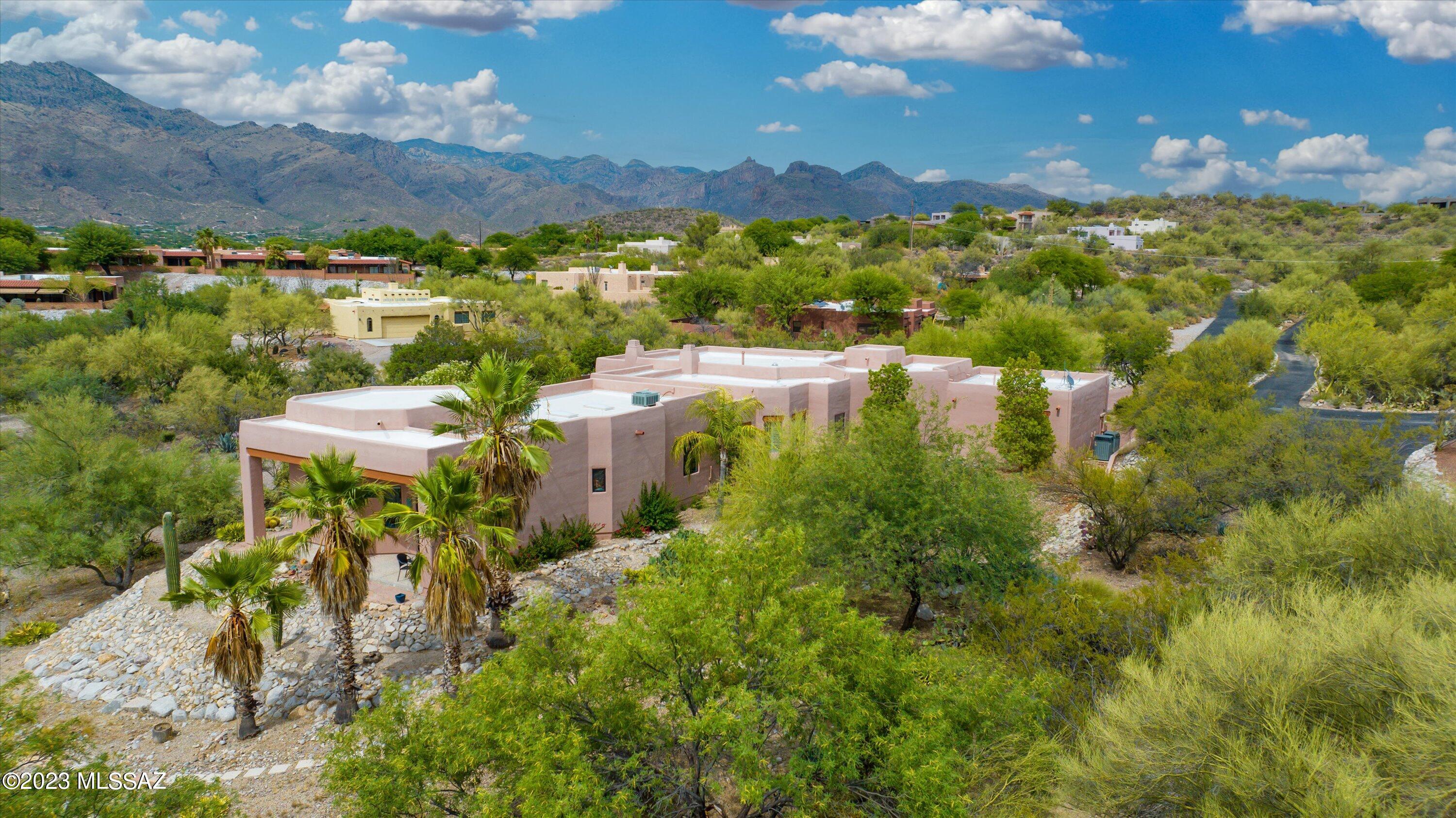 Majestic Mountain Views! Located in the desired Catalina Foothills is this stunning and Unique Santa Fe custom home. Nestled on 1.22 acres with an amazing 1372 sq. ft. artist's studio/guest quarters. Soaring ceilings, built-in bookcase, beehive fireplace, plantation shutters, tile throughout and walls of windows are just some of the features.  Updated Kitchen boasts large breakfast bar island, granite counter tops, double oven, electric cooktop and SS appliances. The primary suite has its own personal beehive fireplace, socking tub/separate shower and slider that leads you to the patio's breathtaking views of the Catalina Mountains. Minutes from excellent restaurants, shopping & hiking. No HOA! 
Come take a View!