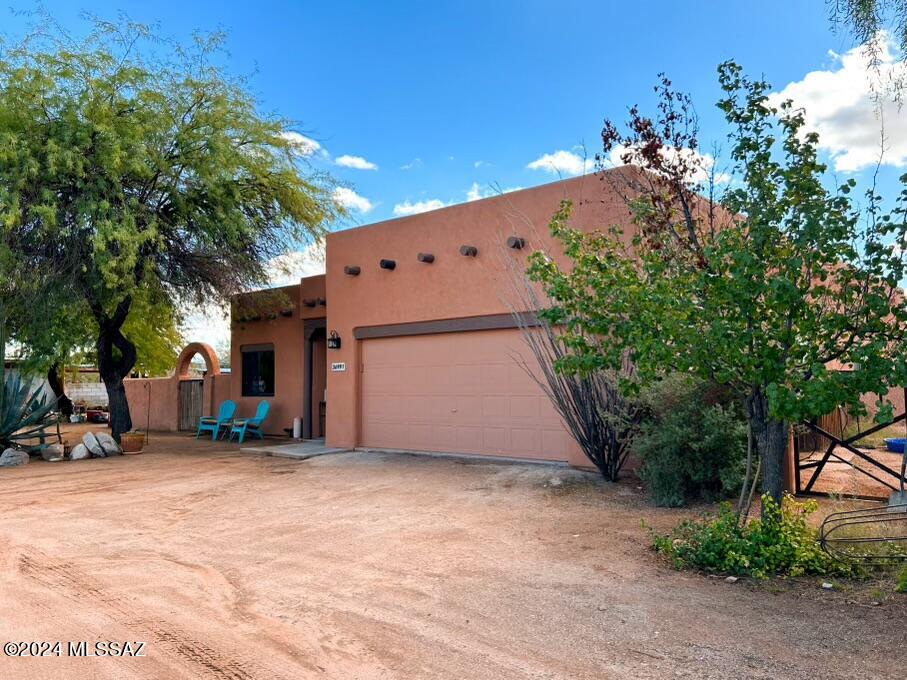 Horse property with a custom home on 2 acres for sale in Marana, Az! Within the 1,683 square feet is 3 bedrooms, and 2 bathrooms with many upgrades throughout the home. You will find new tile flooring, exterior paint, appliances, bathroom vanity, and energy efficient windows! The AC system has been recently replaced and the roof re-coated. The custom, saguaro spine shutters in the living room and bedroom to enhance the rural desert life. Find yourself relaxing by the beehive fireplace or outside taking care of animals in the barn on your fenced two acres with views of Picacho Peak. With plenty of space, this home offers so many opportunities to create your desert dream out of the hustle and bustle of the city.