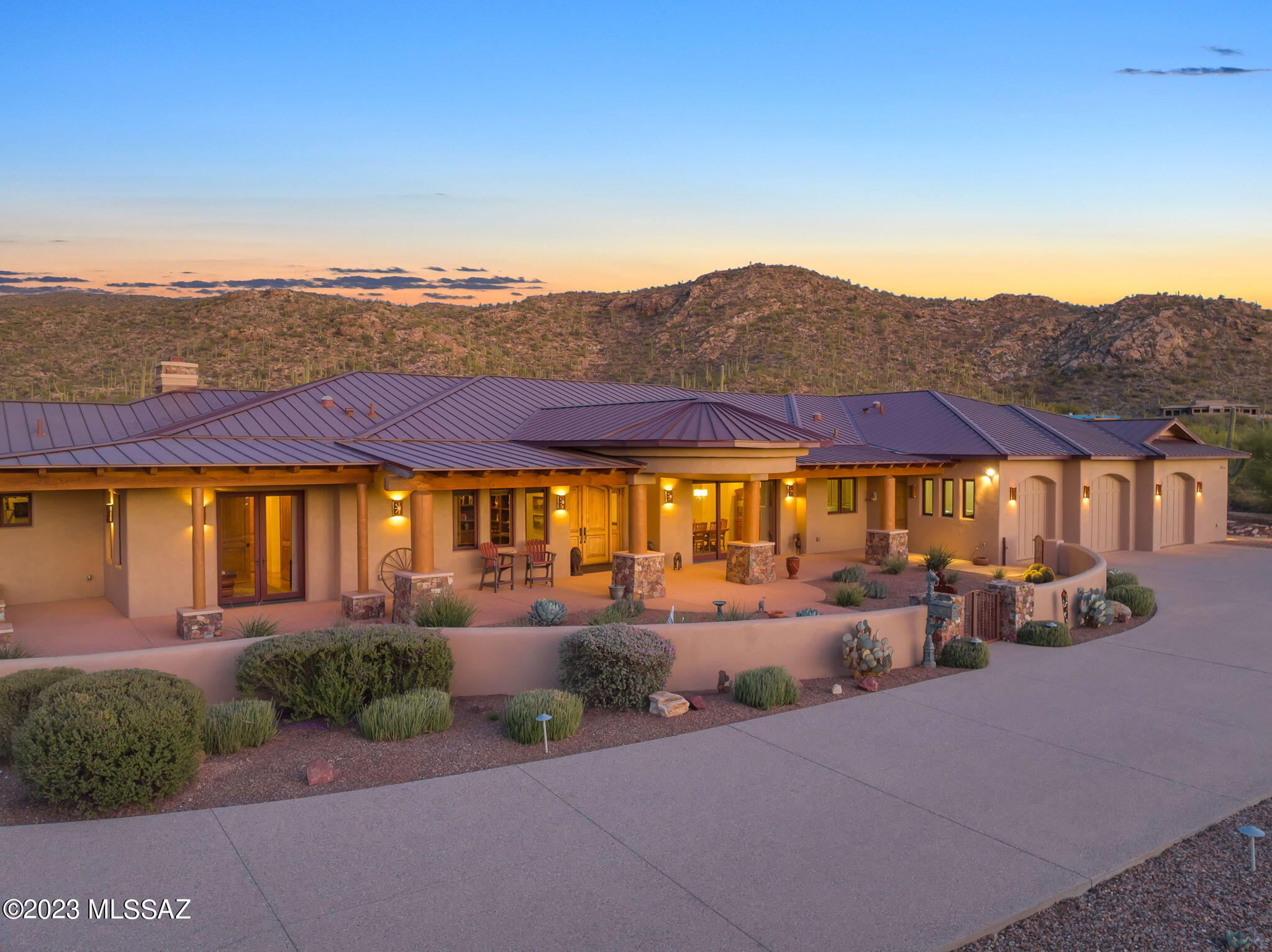Welcome home to casual elegance. This custom home is privately nestled on 5.9 acres in the Tanque Verde Valley with a large well designed 3-stall barn facility and arena. The property has a private well and city water. Custom home builder, Rubicon Homes, with architect, Southwest Habitats, built unmatched quality and attention to detail in this 5-bedroom, 4-bath, 5069 sqft estate.  A private gated entry leads to a long tree lined exposed aggregate driveway, irrigated low-care landscaping with lighting, inviting front courtyard, and ample guest parking.

Entering the foyer, you're greeted with coffered and exposed beamed latilla ceilings and scored colored concrete floors. The quality is proudly displayed with Sierra Pacific windows, Architectural Traditions alder doors, and... Custom hardwood cabinetry by Alpes Designs. You'll feel right at home and relaxed in the spacious great room with a beautiful rock fireplace, built-in entertainment center, and beverage bar with refrigerator, wine rack, and sink. The 12' windows overlook the large back patio and yard bringing in tons of natural light.

The split bedroom / multi-generational floor plan has tremendous flexibility. The primary suite is a complete retreat. Bedroom with fireplace, vaulted beamed ceilings, a huge luxury ensuite with separate vanity sinks, double head shower, and jacuzzi soak tub. Dual closets with custom built-in shelving and ironing board, wall safe. A separate workout / gym room with lots of natural light and outdoor access. The split wing has 2-bedrooms, 2-baths plus a family room / hobby room providing the perfect set-up for teens, in-laws, or guests. The oversized 3-car garage has a generous storage room. The outdoor areas incorporate multiple views of the Rincon and Catalina Mountains, the Tanque Verde Valley, and gorgeous sunsets. The covered patios, built-in BBQ station, and fire pit provide comfortable outdoor living spaces to enjoy with family and friends.

The barn facilities are an equestrian's dream! Masonry barn with a heavy-duty metal roof has three large stalls, 12'x16', 12'x16', 12'x12' with automatic water system, rubber mat floors, and large runs. Sliding barn doors lead to an extra wide isle way with rubber paver flooring and grooming area with hot and cold water. Tack room has tons of storage, sink, toilet room, washer & Dryer. The maintenance room is the perfect place for more storage, feed, and equipment. A hay storage area with concrete flooring at one end of the barn allows easy access from its own service entry to unload feed and hay. The facility has a security camera system, audio system, and WI-FI making this an enjoyable place to spend time with the animals.

Also included is a bonus/caretaker's room (336 sqft.) that includes a kitchen, bath & shower, great room, with heating/cooling.

The irrigated riding arena is 100'x200' and is accompanied with turn out pastures. Access to miles of private trails start right at your driveway for hours of riding enjoyment! Come see this spectacular property today! EZ showings are by appointment only. Listing broker is related to seller.