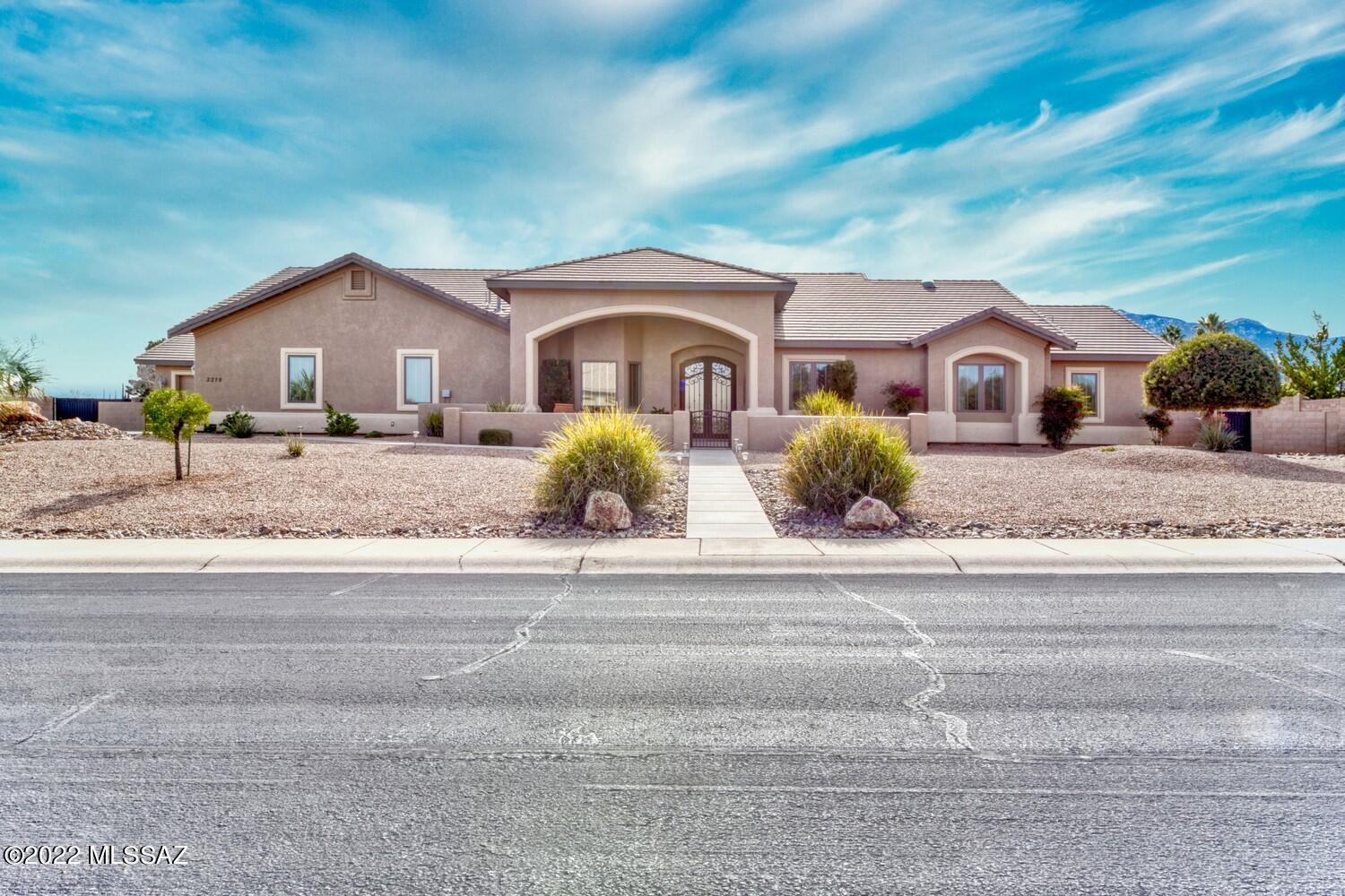 This is a Walston Custom home with tremendous views of the Mountains. This 3553 sq ft home has formal dining, 2 living areas, 3 sided fireplace, high ceilings, 3 bedrms, office/den, Bonus rm, 3.5 baths 3 car garage extended width & depth, approx 2 car workshop/garage with 200 amps for the workshop & another 200 amps for the home. The kitchen is split into 2 areas with 2 dishwashers, 2 sinks, 3 ovens & granite counter tops. There are 42 doors for storage in the kitchen. All appliances are stainless steel & gas range is new. All Lower cabinets have pull outs & some of the uppers have a separate space for storing spices. Seller to provide up to 1% of buyer's loan amount to buy down the interest rate. Home owners are real estate agents. Click on More to see more information about home This Walston custom home has tremendous views of the mountains. It feels like you can just reach out & touch the mountains.  Two different sidewalks lead you to an Inviting courtyard before you reach the front entry with two custom double 9 foot arched wrought iron & glass doors.    Upon entry, to the left is  a spacious dining room with trey ceilings, a tiled serving bar and room for hutch and direct entry into the kitchen.  Directly ahead from the entry is the Great Room W/12 Ft.+ ceilings and open space for decorating.  A wet bar with custom storage for drinks and glasses.  Directly ahead are French doors with access to a roomy tiled patio and outstanding views of the mountains and a tiled sidewalk leads to a cooking patio and access to a 1000 SF workshop.  To the right of the Great Room is a large master bedroom with built-in storage, bath with walk in tiled shower, large linen closet, large walk around closet and an adjoining laundry room that has a space for a sewing machine, and a folding counter, a utility sink, and large storage closet for supplies and seasonal storage.  A huge Main bathroom with a large soaker tub separates the #2 (12x14) and #3 bedroom (12x12) from the Master bedroom. #2 Bedroom has a walk-in closet W/extra shelving & #3 bedroom has 2 closets.  To the left of the Great Room is a 3-sided gas fireplace which heats the Great Room, Family Room & Kitchen.  Family rm also has 12 Ft+ ceilings and an area with a game table W/interesting architecture to show off the game table area.  Off the Family Rm  is a generous size office W/3 built in desks W/10 X 4 Storage Closet & an entertainment center.  The large 13 x 14 bonus room can be an exercise room, mancave, or even guest quarters since the third bath is very close.     From the Family Rm is Directly opposite of the Family Room is the kitchen with granite counter tops and tumbled stone back splash, 3 ovens (2 gas & 1 electric),  2 stainless steel sinks, 2 dishwashers, 42 cabinet doors, lots of drawers, huge storage with 2 pullouts for each of the lower cabinet doors, & built in spice racks. Direct access is provided from kitchen  to the dining room.   Both dishwashers are raised for easier use & adds an interesting dimension to the kitchen and additional storage with a drawer beneath the dishwashers.  A large walk-in pantry with adjustable Melmic shelves & counter space W/more pull outs is convenient to the kitchen.   In this area is a broom, etc. closet & mud rm with an isolated outlet for a freezer and counter for the catch all when you enter the home.  These rms are directly at the entry to the extended 3 car garage.   There are a number of items through out the home like electrical outlets in the 2 medicine cabinets for our electric toothbrushes etc., light switches designated for outside electrical outlets to make it easy to turn on Christmas lights etc. & lighted niches.   There is a soft water system & R/O water available at both kitchen sinks and refrigerator.  2 HVAC systems separating the living from the sleeping areas of the home to help with the energy bills.  The workshop/garage is approx. 1000 sq ft serviced by 200 amps with another 200 amp for the home.  Workshop/garage has water & many electrical outlets W/bathroom nearby.   Both the workshop & the garage floors have been recently redone with a polyaspartic type epoxy floor paint.  A 3 foot wall installed around the added flooring to the storage space in the attic keeps insulation out of the stored items.  Anderson windows and faux wood blinds are found throughout the home.  Landscaping includes only plants that do not go dormant in the winter months.  Very low maintenance landscaping with all plants on a watering system that has 5 separate areas set up on the watering system.  There is also a fence separating part of the back yard for use with the shop  so the outdoor supplies & items are never in view.  An 8 x 12 storage building placed on a generous concrete slab & a raised garden spot with water set up for the garden.  The huge driveway area allows backout from garages and to drive forward into the street.