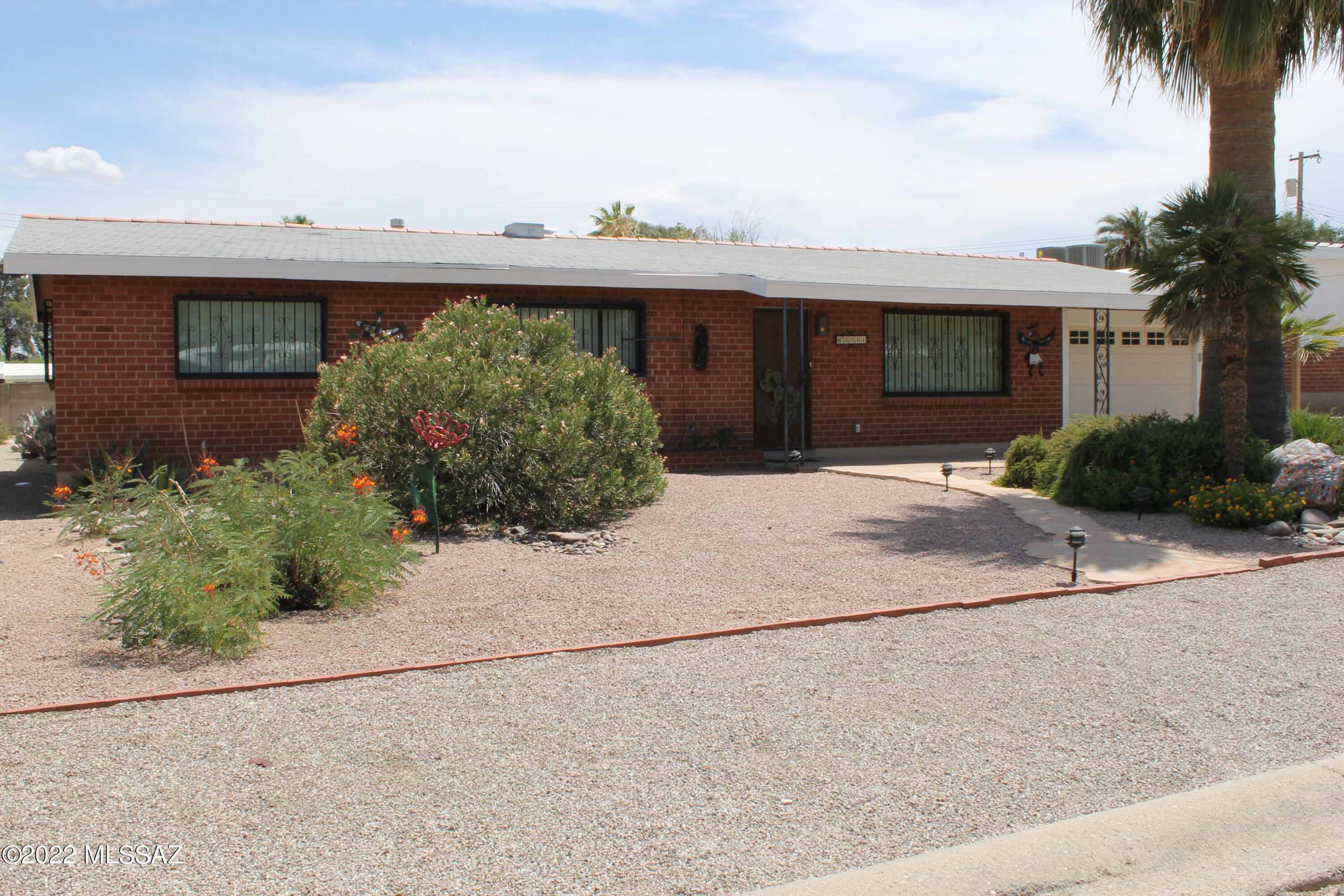 This is a charming well cared for home in the heart of Tucson. This home features many mid-century design features that have been maintained and support that retro feel. The home is comprised of 3 bed, 2 bath, laundry room, sitting room, and single car garage and single carport. Both front and back yards have desert plantings and will be easy to maintain. The home also features a large shed which is separate from the living space of the backyard.