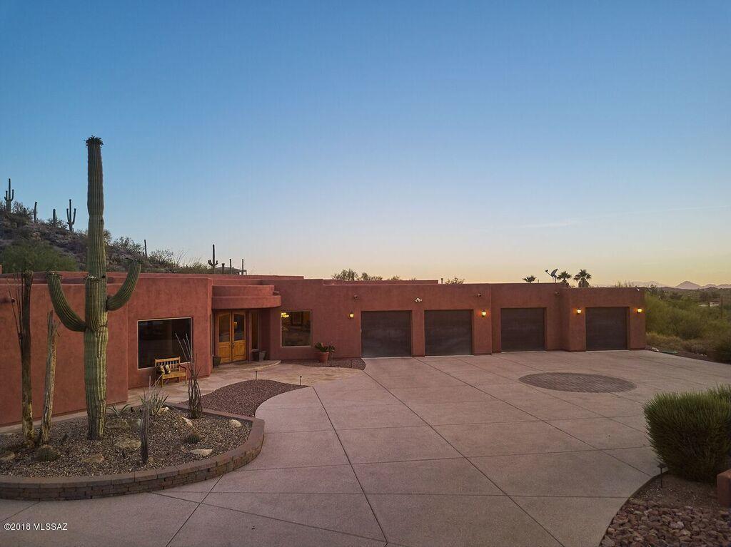 Stunning views of the Santa Catalina mountains surrounded by tranquil desert landscape. Perched in the middle of 3.75 acres, this entertainer's dream is a must see! Enter through your private gate to this magical home, complete with granite counter tops, vaulted ceilings, huge gourmet kitchen, Bose surround sound, and soundproof entertainment room w/full bar perfect for private parties or mother-in law suite. The 4900 sqft home utilizes the space to its highest potential having the master on the east side of the home and all other rooms to the west creating a private soundproof master bedroom. Explore the vast backyard, with a reverse negative edge pool, private spa and a wrap around flagstone patio with covered by a built in mister system.