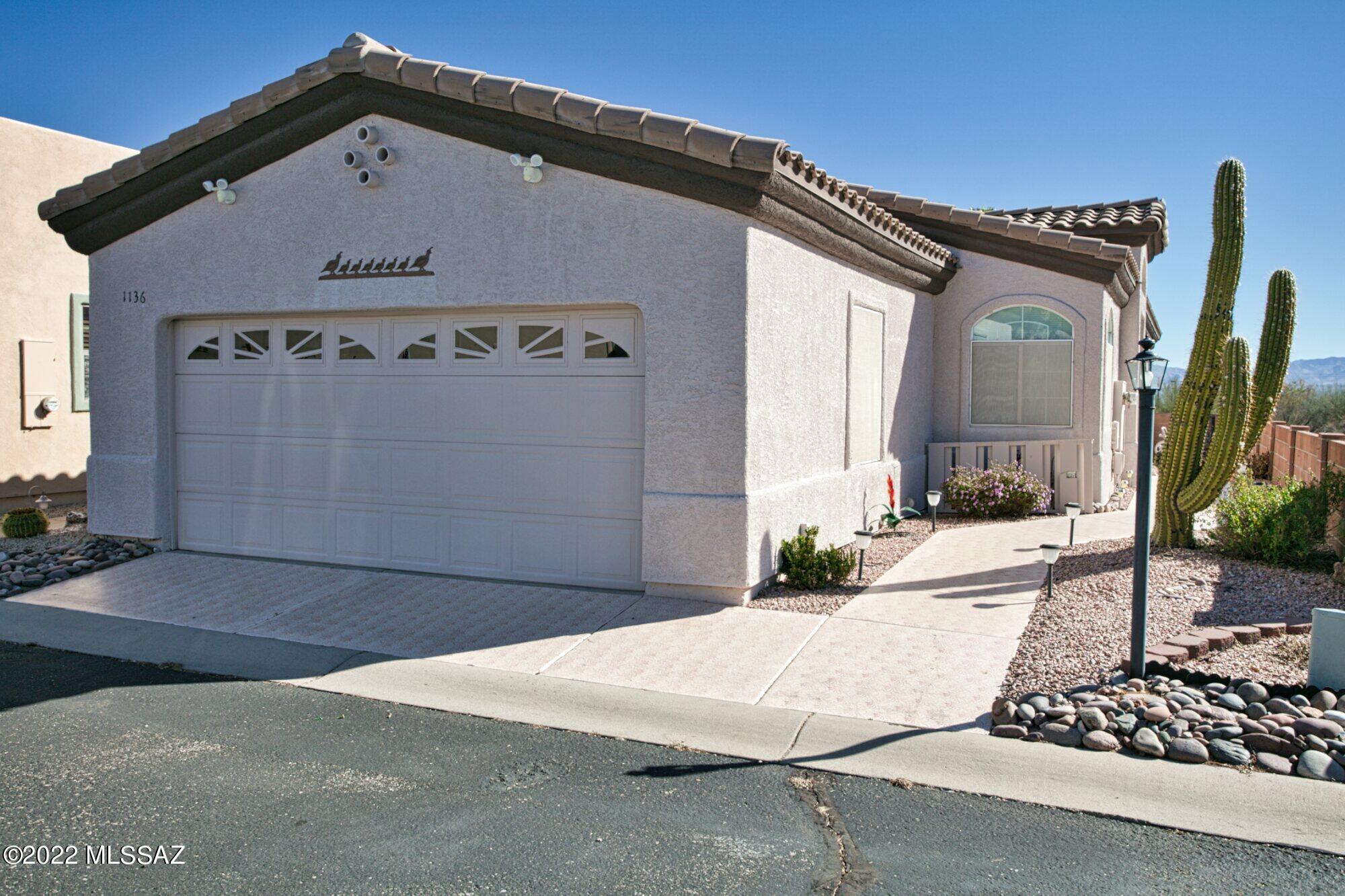 Rare single family home in Canyon View. And does it ever have a view! There are no homes behind the patio and just desert leading to a an expansive view of the Santa Ritas. This lovely home with a two-car garage is priced well and can be purchased furnished.  You will love the soaring ceiling in the great room and the well-organized kitchen that opens to the great room.  The home has a bonus space that can be used as an office, a den or a sewing area. The split bedroom plan checks off a box on your list of desirable attributes for a full time or vacation home. The patio has full privacy and lots of green to enhance the area. Canyon View has its own rec center but GVR is available.  One of the prettiest and most modern homes in this friendly community! Please visit.