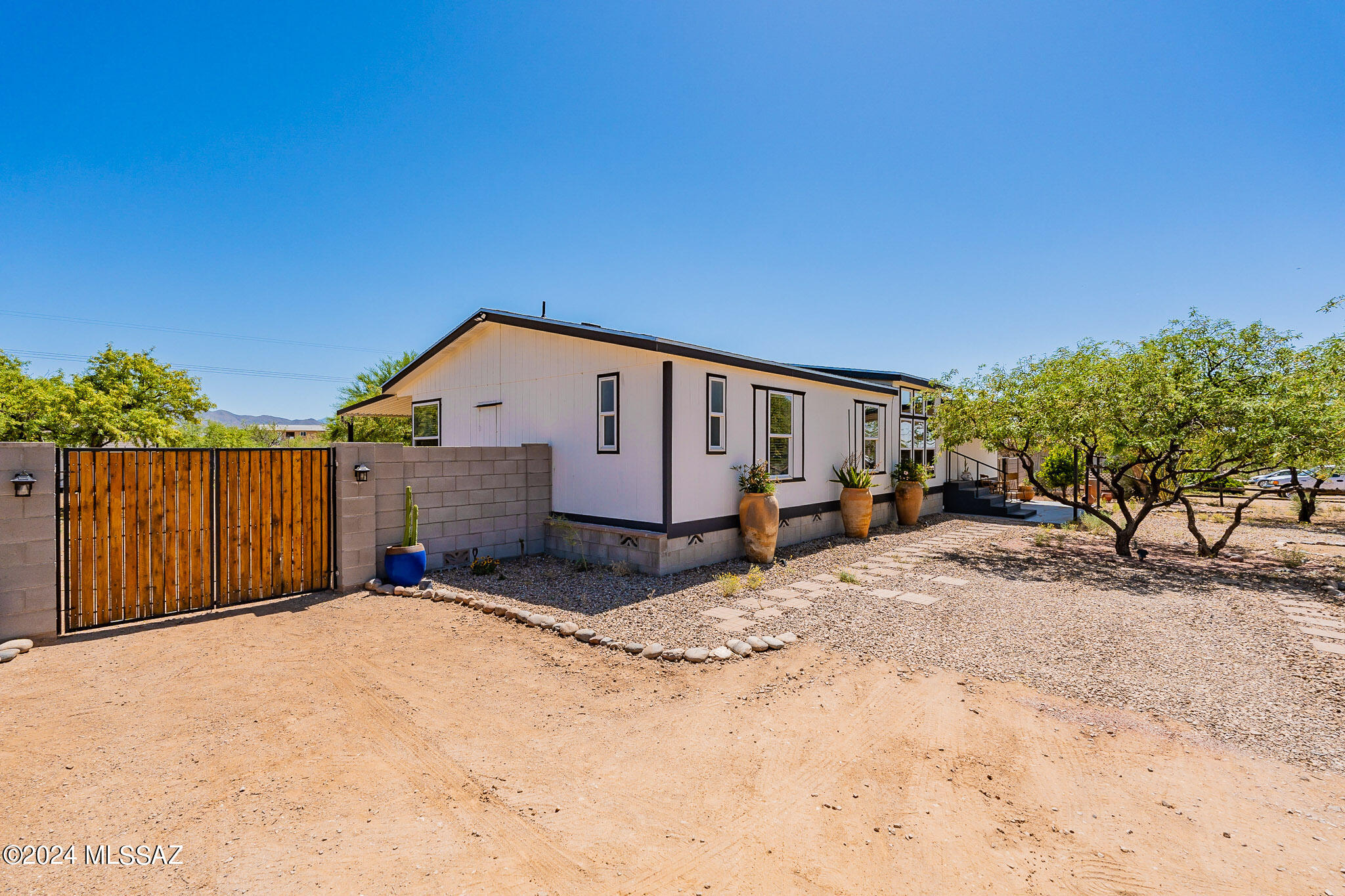 One of the best lots you will find in the area, with NO HOA and with 700 feet of new cement block fencing surrounding the entire backyard! You have your privacy on one full acre, living the country life that you have always dreamed! Even 3 chickens and chicken coop!! 2022 AC, New Roof in 2023 and the home meticulously taken care of. Large shed or workshop or even future guest house if you brought utilities to it! Inside there are 3 bedrooms PLUS a den with double doors to provide an office space or play room. Kitchen has an island and a cozy breakfast nook with bay windows. Couple of driveways for ample parking and a double gate for extra in the back. Get yourself out of the craziness of the city and enjoy the quiet country life of Vail!