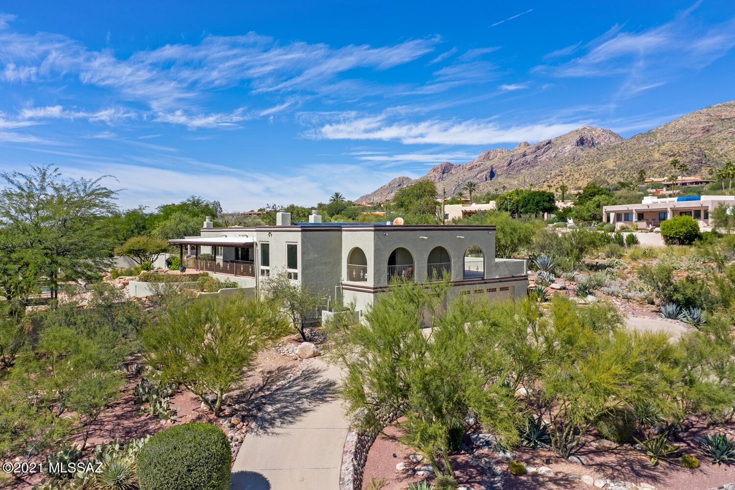 Perfectly situated to capture city and Catalina Mountain views, this elegant & updated home is just a few minutes from the best restaurants & shopping at nearby La Encantada. High ceilings and expansive windows showcase our unparalleled Tucson views from every room, while numerous patios and verandas are perfect for relaxing or entertaining outside. The pool, spa, custom treehouse, basketball court, and private garden off primary suite, all complete this nearly one acre estate. Inside there are 4 bedrooms (one is being used as an office) and 4 bathrooms, a gourmet kitchen, and cozy den. District 16 schools, triple pane windows, new heating & air conditioning, premium interior & exterior paint, and numerous other upgrades. 3 car garage and an air conditioned hobby room (not in sqft)
