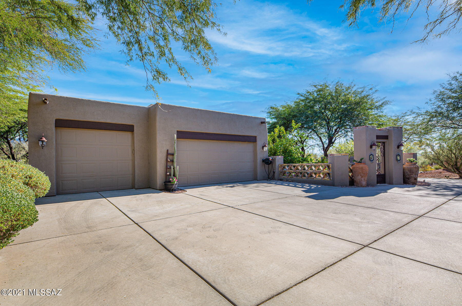 This stunning 2,665 SqFt, 4 bedroom, 3 bath, southwestern style home sits on a large corner lot in the highly desirable Vistoso Estates subdivision, and boasts breathtaking mountain views. 

As you make your way to the entry from the front courtyard, you will be charmed by the custom finishes and display of craftsmanship that surrounds you. The courtyard features a beautiful fountain, large paver patio, fire-pit with bench seating, turf, citrus trees, and is the perfect spot to take in some amazing sunsets.  

Once inside you will be captivated by the the picturesque Catalina Mountain views, and delighted by the open concept split-bedroom floor plan, with imported old world doors, ceramic tile, plantation shutters, and ceiling fans throughout. If you love to entertain you will thoroughly enjoy the full open concept kitchen and great room. The kitchen is appointed with corian countertops, stainless steel appliances, gas range, and large island with bar seating. The dining room is spacious and features a large custom pantry and butler pantry. The expansive great room completes this open concept theme, with ample space for family gatherings or entertain guests, while the gas fire place invites you to create a separate intimate seating area.  

If you like privacy the split bedroom floor plan is sure to please, as alluring double doors lead to the sizable master suite with mountain views, double vanity, custom multi-head shower, and large built-out walk-in closet. Bedroom two is appointed with a rustic hand-carved door, mountain views, and could easily be utilized as an office or studio space if so desired. Bedroom three offers expanded closet space and is adjacent to a full hall bath. Bedroom four features an ensuite bath with tub and shower and large walk-in closet.
The laundry room offers custom cabinets and a stackable washer and dry, and provides access to the garage. The extended three car garage has specialized floor coating, a work bench, and built-in shelving for plenty of storage. 

Leading from the great room are artistic iron doors that fully open to invite you into your backyard oasis, featuring a heated pool and spa, outdoor kitchen with built-in BBQ, and well manicured landscaping. The large paver patio makes for the perfect place to relax, soak up some sun, and enjoy the sensational panoramic mountain views!

This beautiful property is truly one of a kind and is ready to welcome your home!