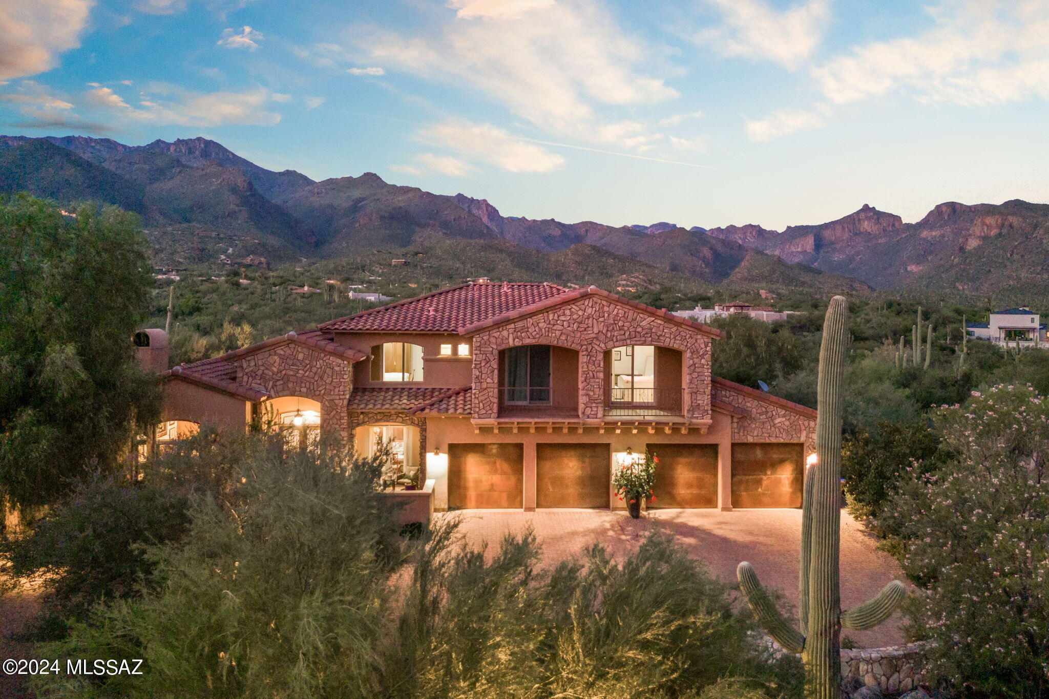 Perfectly situated on an incredible lot in the small, gated community of Ventana Reserve, 7455 E Quiet Mountain Place presents a rare and remarkable opportunity. Lots like this one are nearly impossible to find, as are newer homes in the Catalina Foothills. Situated in a cul-de-sac on a pie-shaped Northeastern facing 1.65-acre parcel, abutting open desert and showcasing the most dynamic mountain views available. The privacy and experience here are unmatched. Designed and originally occupied by the developer, the layout and amenities of the property are flawless. The carefully crafted front elevation and paver drive make way to a 4-car garage (over 1,000 sq ft), complemented by thoughtful desert plantings and mature trees. A gated courtyard & sculptural fountain leads to the main entry. Interior space spans 4,547 square feet (5 bedrooms, 4 ½ baths, den & loft), with ample separation, while maintaining an open living area. Elegant and timeless materials are included throughout. The lower-level lives generously in the public spaces, and includes the primary suite, a guest room, full guest bath, along with a spacious den. 

The upper level provides a large loft with an incredible vantage point to take in the mountains. Ideal for families or visitors, there is a bedroom with an ensuite, plus 2 additional bedrooms with a jack & jill bath. Each bedroom enjoys access to an expansive front balcony, perfectly positioned to enjoy sunset.

Indoors and outdoors connect by way of stacking sliding doors for seamless flow to the full-length terrace and an extraordinary desert oasis. Cocooned by mountains and lush vegetation, the setting is picturesque. The backyard offers ample space surrounding the swimming pool & spa, an outdoor kitchen, areas for gardening and multiple seating locations. The lot size, wide side yards and positioning of this home create seclusion and a dramatic connection with the desert.

The benefits of living in this location are many. Far from any busy streets, residents enjoy a peaceful and quiet setting in one of the top-rated school districts in Tucson (Catalina Foothills). Sabino Canyon is 1 mile to the east, featuring some of Tucson's best hiking trails and a 3.5-mile paved road for walking or running. Also, within a mile, there is an elementary & middle school, multiple restaurants, a grocery store, salon, bank, and other amenities.  Ventana Country Club is easily accessible for social, fitness or golf memberships.