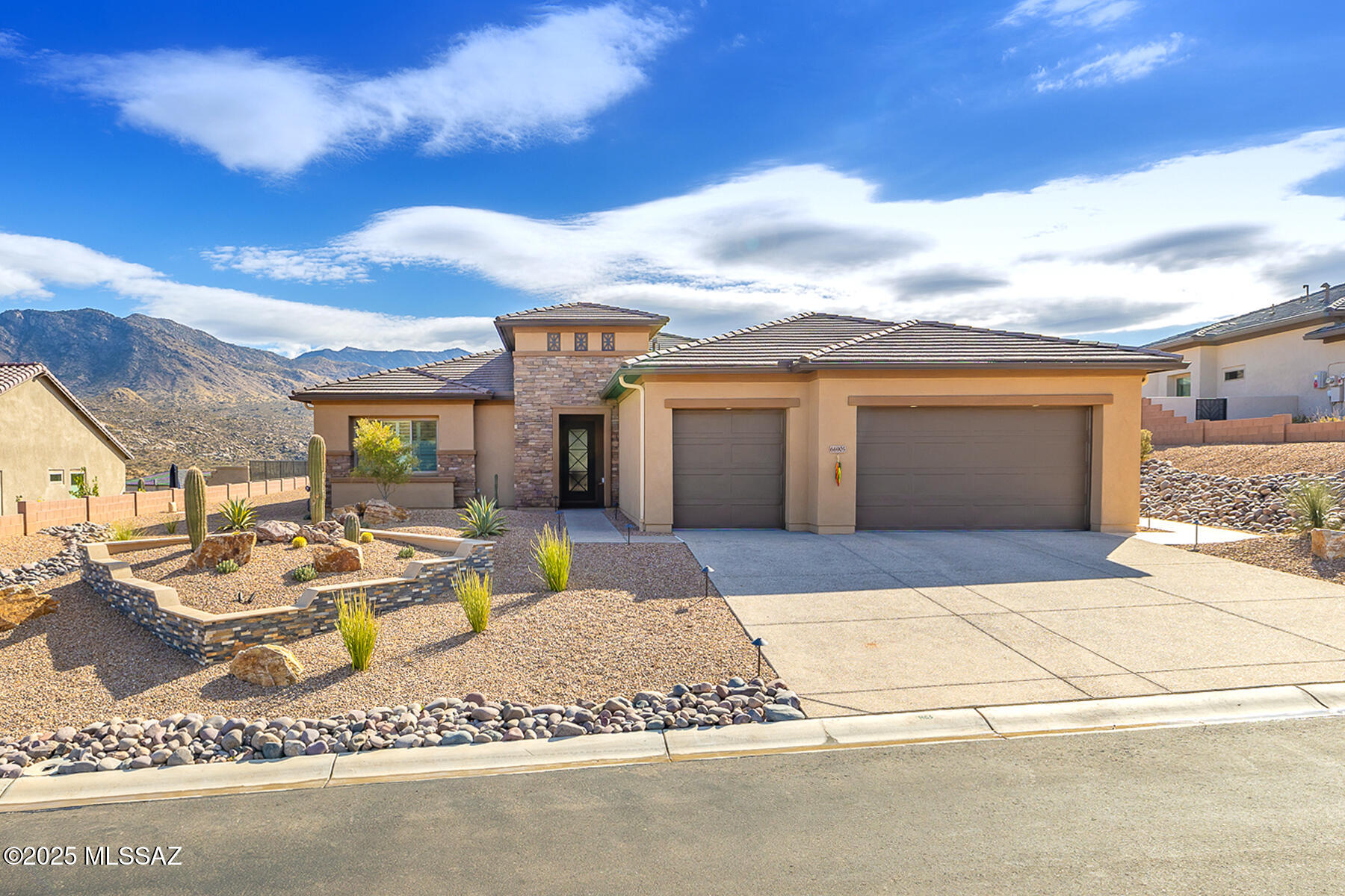 Exceptional, newer 3BD/3.5BA +Den (3,227 sq ft) Bacara model on premium .32 acre view lot in SaddleBrooke Preserve showcases contemporary flair and breathtaking Catalina mountain views. This highly upgraded, open concept plan boasts Luxury Vinyl Plank flooring, 3 en-suite bedrooms with carpet, Cambria quartz countertops, plus indoor/outdoor fireplaces and delightful water feature. Enter to find an expansive gathering room ideal for relaxing or entertaining with family and friends. This grand room is highlighted by walls of windows, ledge fireplace with large format tile surround, plus an extended wet bar. Spacious dining area adjoins a gourmet kitchen hosting curved island with bar seating, upgraded cabinetry, Wolf/Sub-Zero/Cove appliances including 6-burner gas cooktop, plus a wine and beverage refrigerator and butler's pantry. Elegant Owner's suite hosts luxury bath with dual sink vanity, soaking tub, separate shower and custom walk-in closet. Two guest rooms with shower plus powder room and Den with glass paneled French doors. Additional upgrades include whole house water treatment system, whole house surge protector, tankless water heater, EV charger, plus dual overhead storage racks in the 3-car garage with epoxy coated floor. Relax on the extended Travertine patio while enjoying a trickling water feature, serene wraparound views and professionally designed landscape. SaddleBrooke's premiere Active Adult community. Perfect for the most discerning buyer!