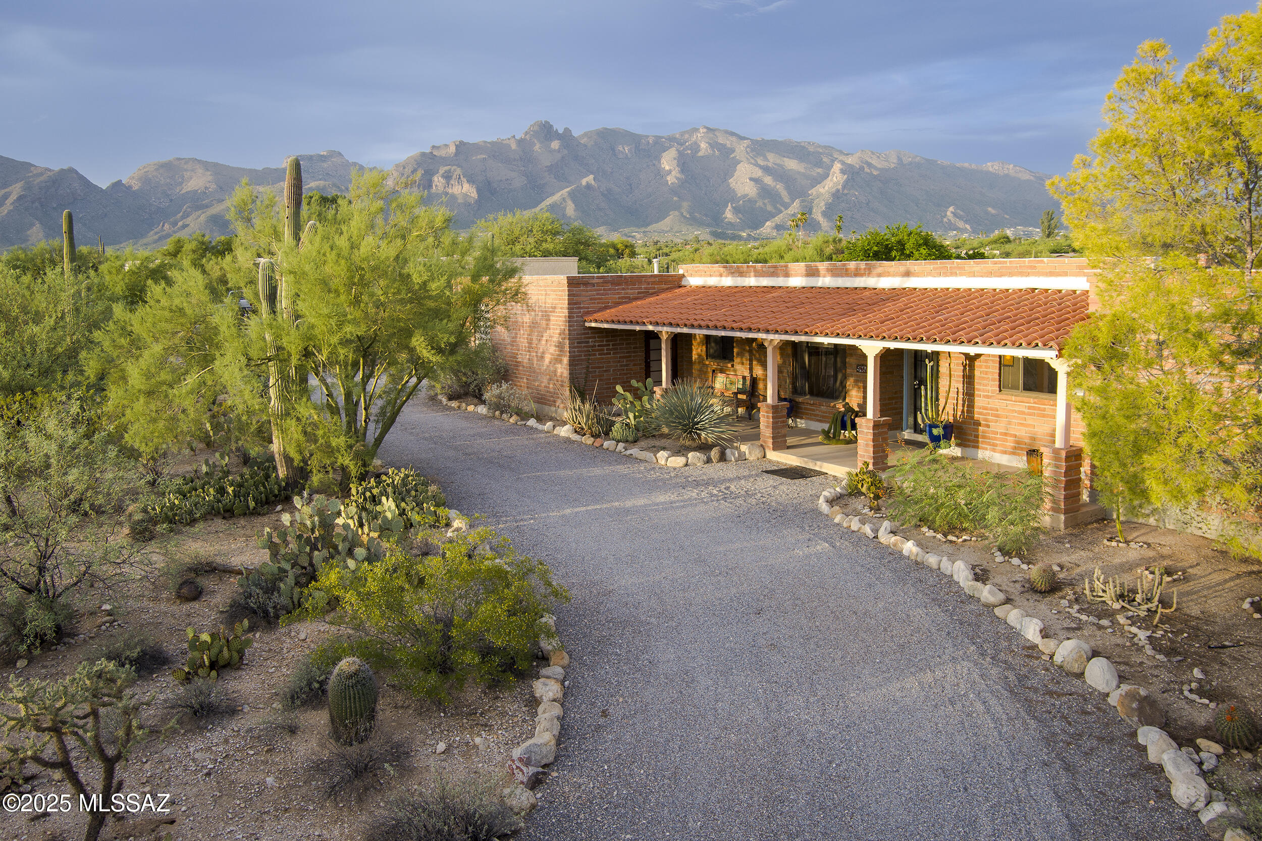 Situated on over an acre in Catalina Foothills Estates No. 7, this classic territorial Tucson adobe home offers privacy, views, and timeless Southwest charm. The property is warm and welcoming, meticulously maintained with an updated kitchen and primary bath. The home features a spacious layout with well-separated bedrooms, including a private guest suite or 4th bedroom. Enjoy desert sunsets from the front porch,  mountain views from the expansive backyard, dog walks in the wash, lush landscaping, and a sparkling pool for those summer days. Just minutes to Rillito Park Farmers Market, St. Philip's Plaza, upscale shopping at La Encantada, local dining, and the University—this is desert living at its finest. Come feel the energy of this property today, it may just speak to you