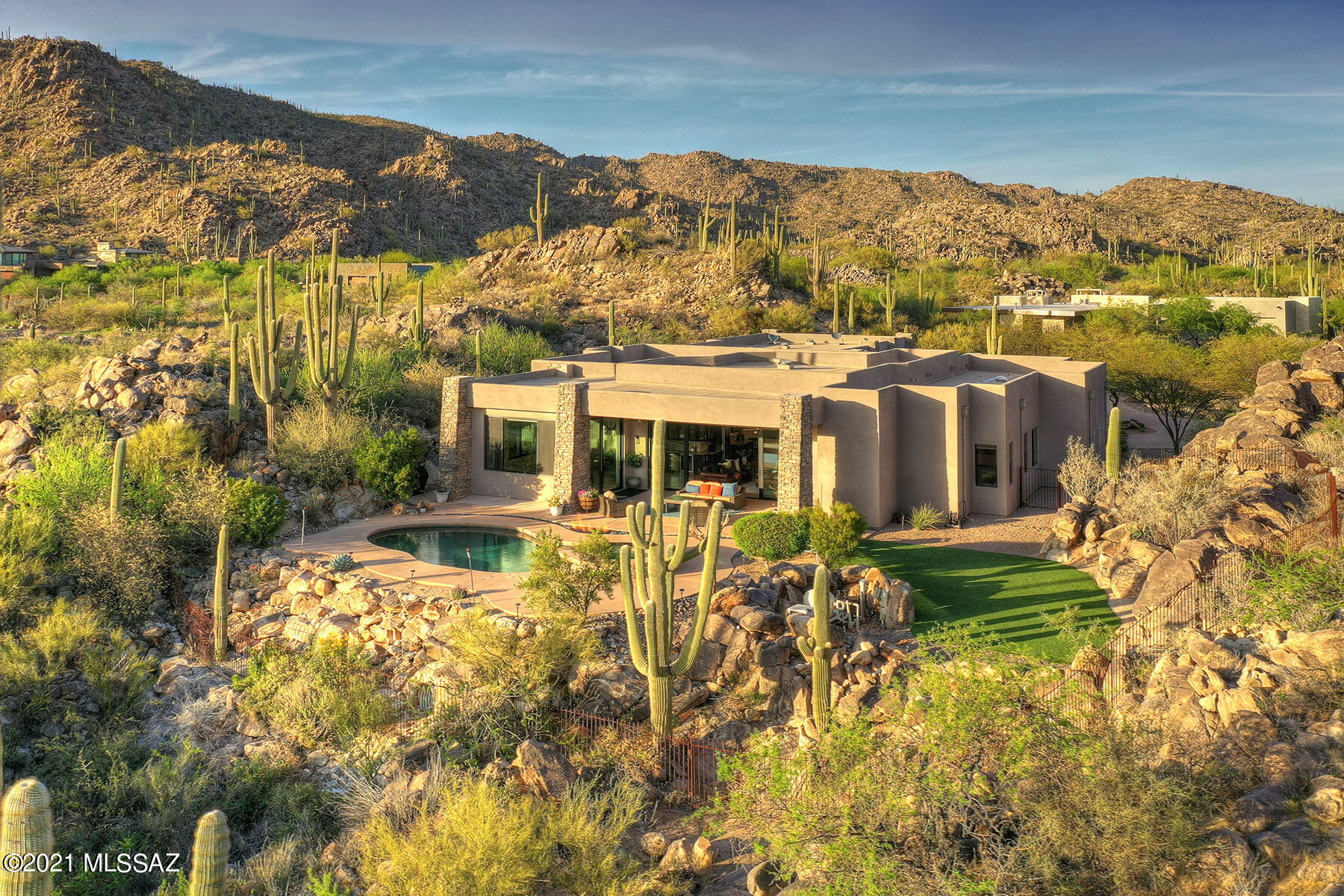 A contemporary design artfully nestled between two natural rock  outcroppings on a 2.36  stunning view lot; recently enhanced through an expansion of the beautiful chef's kitchen, addition of a beautiful wrap-around wet bar w/ Subzero dual 30'' wine fridge & 147 bottle capacity, also featuring gleaming GE Monogram refrigerator & oven, bi-level Silestone quartz island w/chiseled edge & bar seating, brand new dining room w/dramatic stone backdrop & walls of glass framing fabulous views; Great room w/ 20' slider that opens seamlessly to the outdoor living room, sparkling pool, spa & bbq area. New travertine flooring, all in a re-configured floor plan boasting a bonus/rec room/or office, plus exercise room,  mother-in-law suite w/ensuite bath. An oasis in gated/guarded Stone Canyon