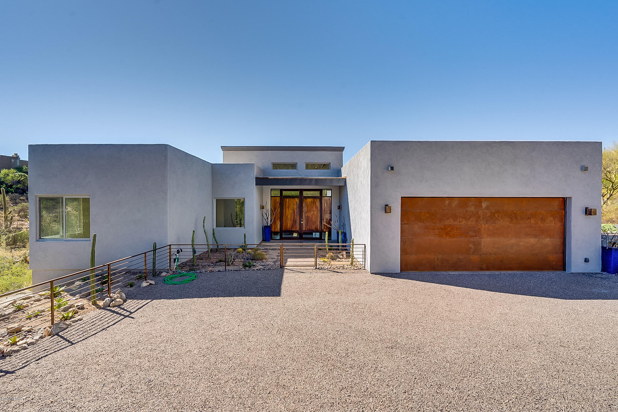 This amazing modern design offers majestic views of the surrounding mountains as well as the city lights. Easy to maintain finishes and large patios offer relaxed lifestyle. 
Floor plan:  3,225 Sq Ft of living area, 720 Sq Ft of exterior living space and 670 Sq Ft garage equaling a combined sq ft area of 4,615 Sq Ft.  3 large bedrooms in a popular split floor plan wrap around an open common space; media room, gourmet kitchen. Large open windows with views of the mountains and the city create an experience of connectivity with nature as well as a sense of serenity.  Enjoy the cool breezes sipping a favorite beverage while watching spectacular sunsets from the privacy of your covered patio w/ outdoor kitchen and bath or star gaze with friends on the sun deck above. Completed Oct 25, 2019