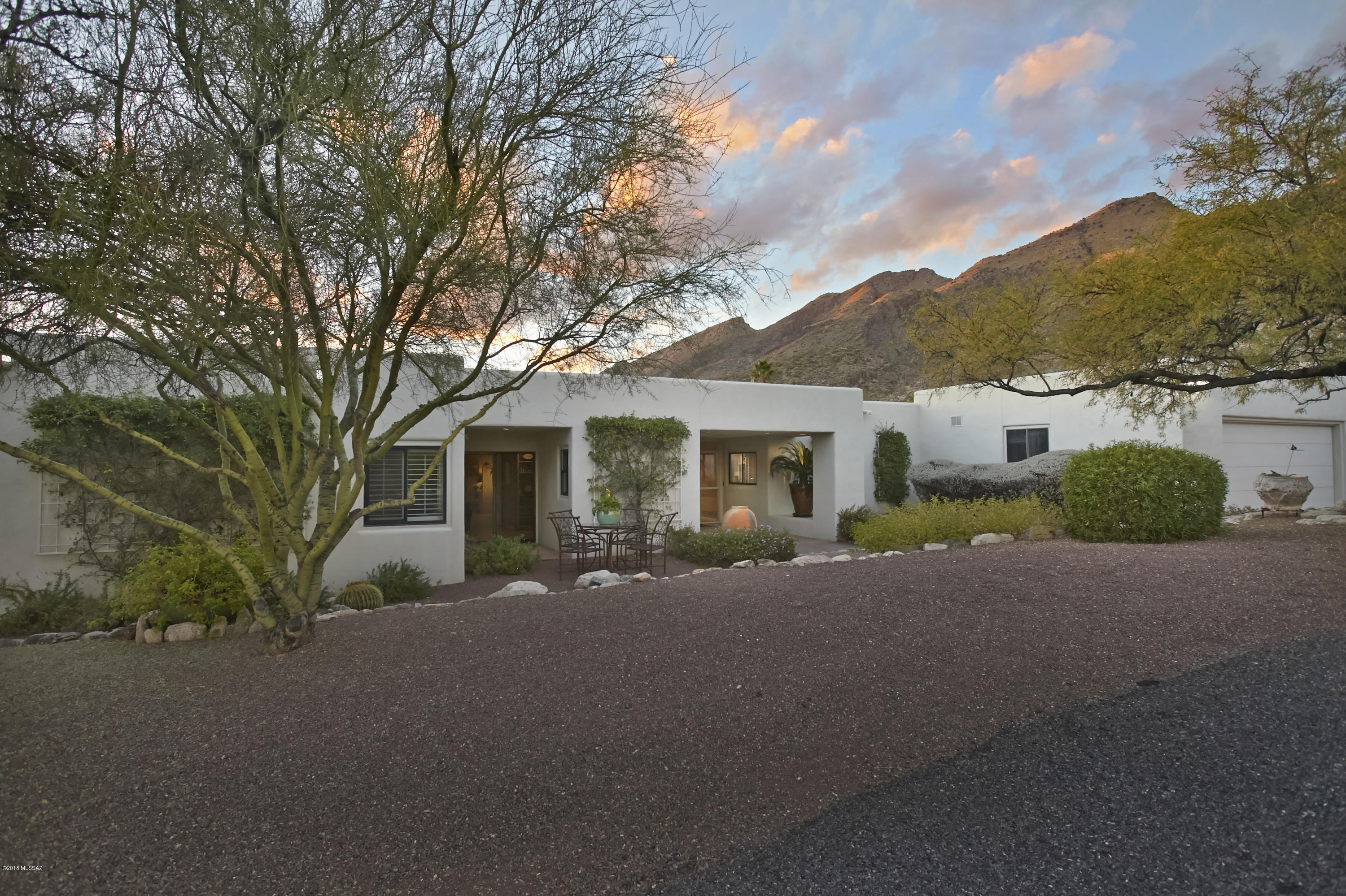 AN IDEAL WINTER RESIDENCE IN ONE OF TUCSON’S MOST PRESTIGIOUS GATED NEIGHBORHOODS, FINISTERRA. THIS BEAUTIFUL HOME EXUDES CASUAL ELEGANCE & OFFERS A VERSATILE FLOORPLAN THAT HAS BEEN TASTEFULLY UPDATED. THIS IMMACULATE PROPERTY FEATURES BREATHTAKING MTN & CITY VIEWS, BEAMED CEILINGS, LIGHT FILLED ROOMS W/WALLS OF WINDOWS, GOURMET KITCHEN W/GRANITE ISLAND & WINE BAR. THE SPACIOUS MSTR SUITE FEATURES A DRAMATIC CITY VIEW, PRIVATE PATIO & 2 WALK IN CLOSETS (1 WAS THE ORIG 4TH BDRM!) THE EXPANSIVE PATIO & WRAP AROUND DECK CREATE AN IDEAL SPACE FOR ENTERTAINING OR ENJOYING A GLASS OF WINE WHILE WATCHING THE DRAMATIC SUNSETS. THE LUSHLY LANDSCAPED REAR YARD W/CITRUS TREES, ROSE GARDEN & A STUNNING WATER FEATURE CREATES A CHARMING DESERT OASIS. CURRENT OWNER HAS TAILORED THE HOME FOR SEASONAL U