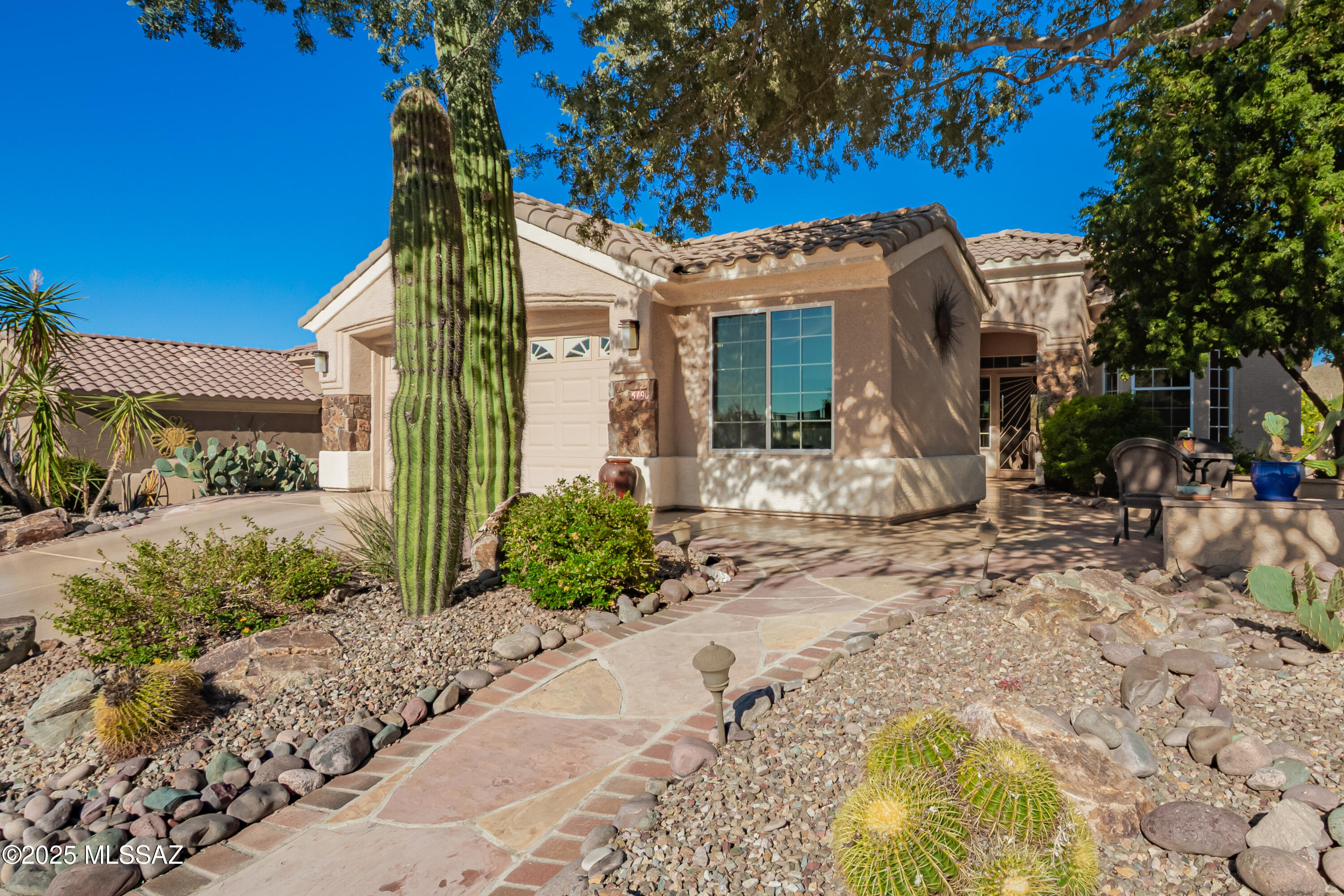 Extended Hillsboro- 1,915 sq ft, 2 bedrooms + an extended den with built-in furniture set on a quiet cul-de-sac with panoramic mountain views, the 15th fairway, and a location perched above the pond. Upgrades include stone-faced front pillars, covered patio, front courtyard, and a 2-car garage with golf cart bump-out, storage cabinets and workbench. Upgrades include new HVAC, water heater, water softener and recirculating pump, remodeled primary bath, extended kitchen cabinets with wine cooler, additional primary bedroom closets and storage, 3 bay windows, 4 citrus trees, BBQ island, large utility room, and a hand-carved stone gas fireplace. Located in an active adult community with an award-winning golf course, pickleball and tennis, pool and hot tub, fitness center, bar and restaurant and numerous clubs and social activities-there's something for everyone. Come see for yourself-these are the best views in town. Close to many hiking and biking trails.