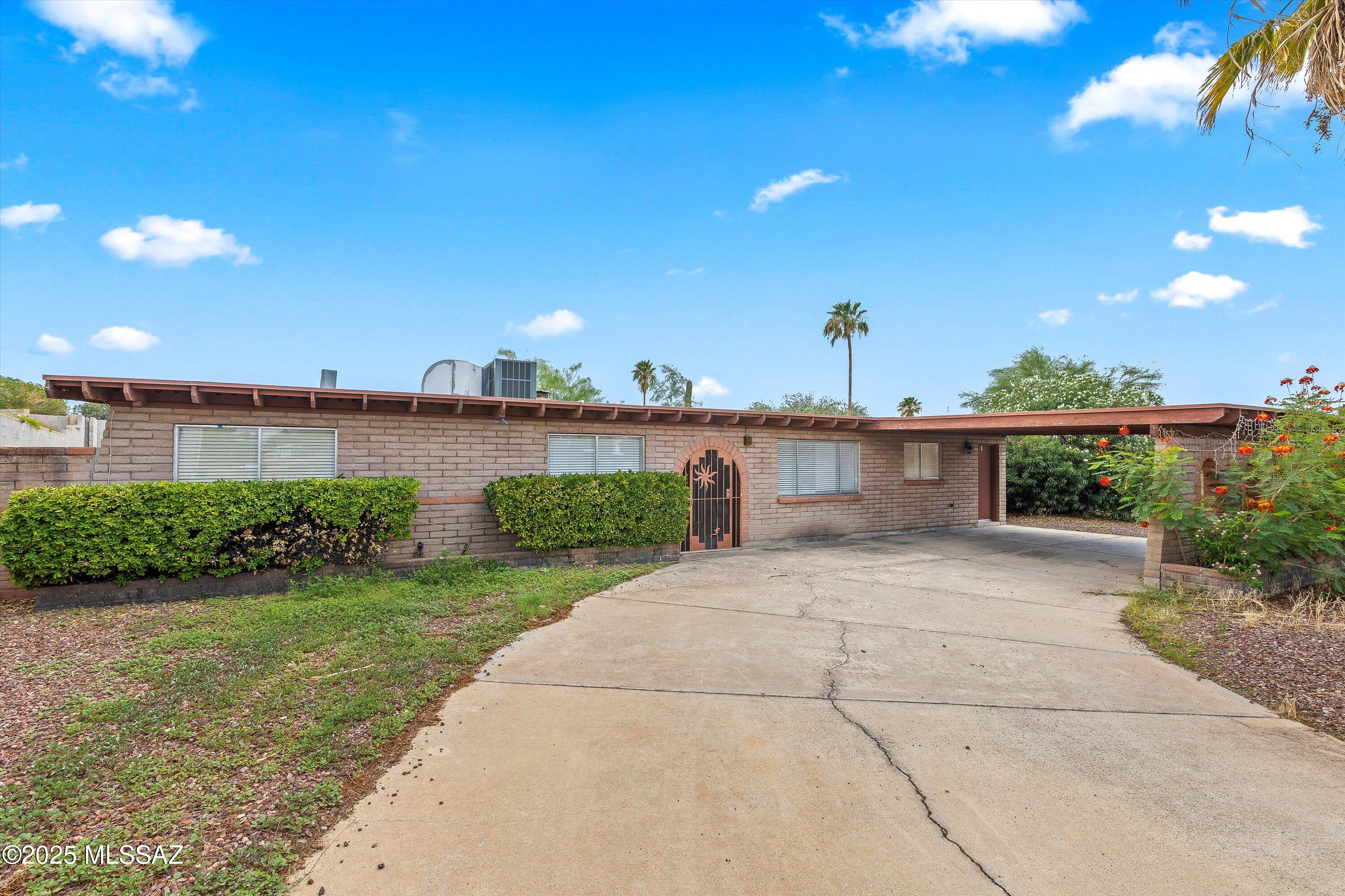 This beautiful slump block home sits on a quiet cul-de-sac, backing up to a peaceful wash for added privacy. Featuring 3 bedrooms plus a den, it offers spacious living with tile floors throughout all common areas. The inviting living room boasts a charming brick beehive fireplace and large picture windows showcasing views of the massive backyard. Enjoy the huge covered patio, perfect for entertaining, and a handy storage shed. The master suite includes a walk-in shower with a stylish tile surround. With its classic design and serene outdoor space, this home is the perfect blend of comfort and character!