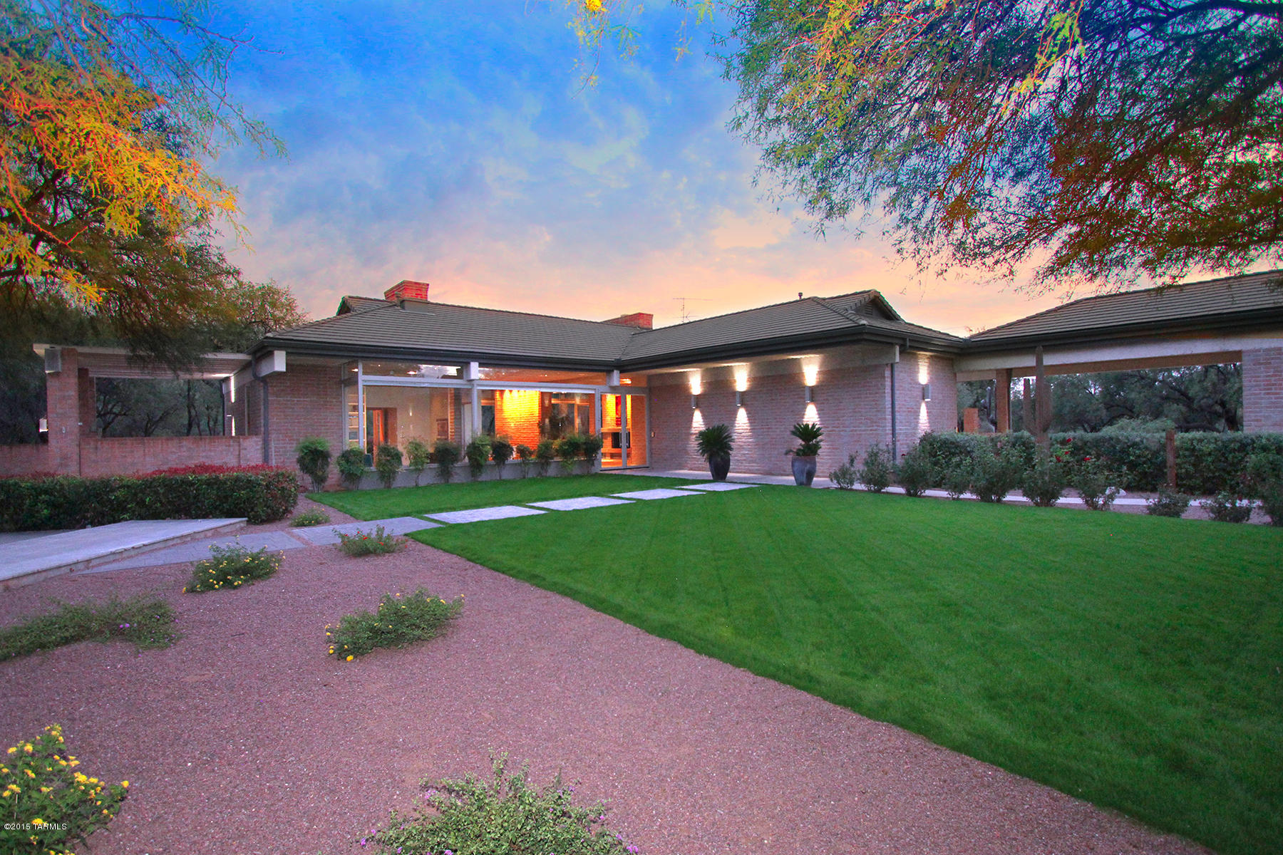 Enchanting gated 27 acre estate in a mesquite forest tucked amidst a rich riparian habitat with abundant wildlife and panoramic mountain vistas. Architecturally significant home boast commanding adobe and concrete walls, soaring wood crafted ceilings and captivating wall of windows that infuses inside with outdoor living space seamlessly to the lush manicured grounds. Equestrian dream with 6 stall breeze way barn, round pen, hay barn, tack room and wash access. Miles of riding or hiking trails at your doorstep. Rare opportunity for quiet seclusion and agricultural designated lot in La Cebadilla Estates with two private wells. Expansive patios and entertaining spaces, fountain, pool & spa surrounded by majestic mountain views and mature landscape makes this a serene tranquil retreat.