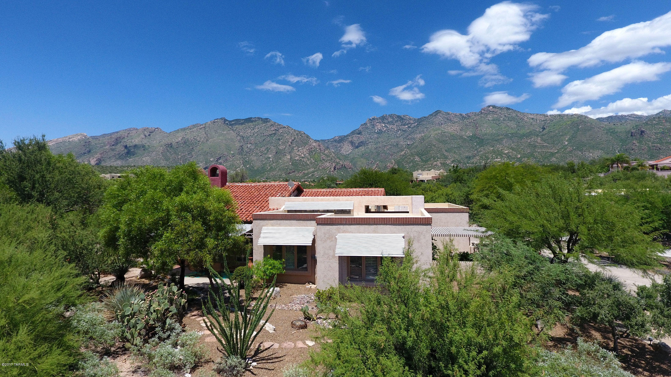Spectacular views, privacy & high-end products & finishes are found in this 1st time on the market home. Dramatic vaulted plank & beam ceilings, walls of windows & glass doors bring Catalina Mtn views indoors. One-of-a-kind features thruout to include a private well. Recently renovated, this home boasts custom set marble & wood floors, granite counters thruout & rich custom cabinetry. The chef's dream kitchen offers a commercial gas cooktop w/grill & hood, SubZero frig, warming drawer & custom drawers/cabinets. One of the 3 fireplace's enhances the huge mstr suite, featuring 2 patios, luxurious spa-like bthrm & lrg customized walk-in closet w/island. The resort-style yard focuses on those incredible views while offering pool, spa, built-in BBQ ctr & multiple patios. Private guest house.