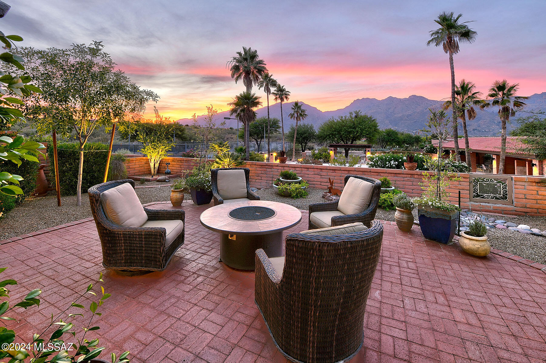Welcome to your slice of luxury nestled in the heart of the foothills! This stunning townhome offers the epitome of refined living with a thoughtful blend of comfort and opulence. Step into sophistication with this meticulously renovated 2-bedroom, 2-bathroom residence boasting high-end finishes throughout. The expansive great room welcomes you with a custom-built entertainment center, featuring hand-carved cabinetry for a touch of artisanal elegance. Entertain with ease in the beautiful kitchen, adorned with stone countertops, imported Spanish colonial style doors, and custom ornamental iron work and pulls. For the wine enthusiast, indulge in the dedicated wine bar and refrigerator, perfect for hosting intimate gatherings or unwinding after a long day. Retreat to the luxurious primary suite, where a custom walk-in closet and spa-like bath await to pamper you in style. Need a versatile space? The secondary bedroom doubles as an office, complete with built-in twin Murphy beds for convenience without sacrificing elegance. Outside, experience true tranquility on the expansive wrap-around patio, featuring an outdoor kitchen/grill area amidst lush vegetation and citrus trees, all sustainably maintained with rainwater harvesting. Embrace sustainable living with owned solar, where eco-friendly living meets comfort and style. Take in the breathtaking mountain and sunset views as you savor every moment in this unparalleled oasis. No expense has been spared in crafting this masterpiece of modern living.