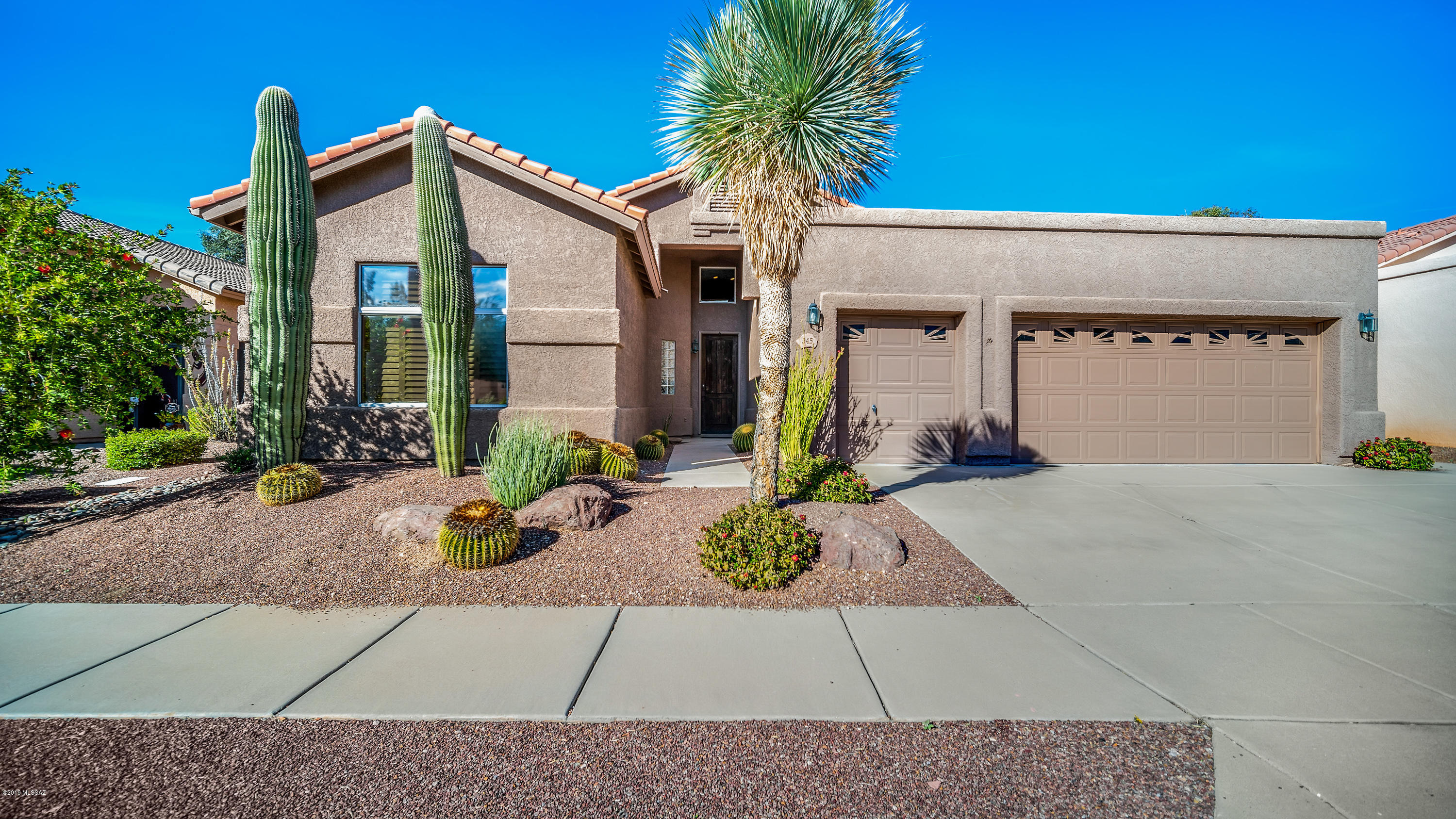 Charming 2 BED + DEN, 2 FULL BATH home located in a small gated community on the 5th Fairway of the Oro Valley Country Club. Soaring cathedral ceilings throughout this split bedroom floor plan. Picture windows in every room; plantation shutters throughout. Custom doors w/ oiled bronze hardware. Large kitchen, which overlooks the great room, boasts custom cabinets w/ pullout shelves, two large pantries, ample storage, and sub-zero built-in refrigerator/freezer. Oversized island with five-burner, gas cooktop and auto downdraft vent system. Perfect for entertaining! 2 car + golf cart fully finished garage with plenty of extra storage. Master bath features dual vanities, large walk-in shower w/bench, and walk-in closet with built-ins. Master suite provides access to tranquil, North facing backyard w/extended, covered patio and beautiful golf course views. Less than a mile from grocery shopping, restaurants, and the country club!