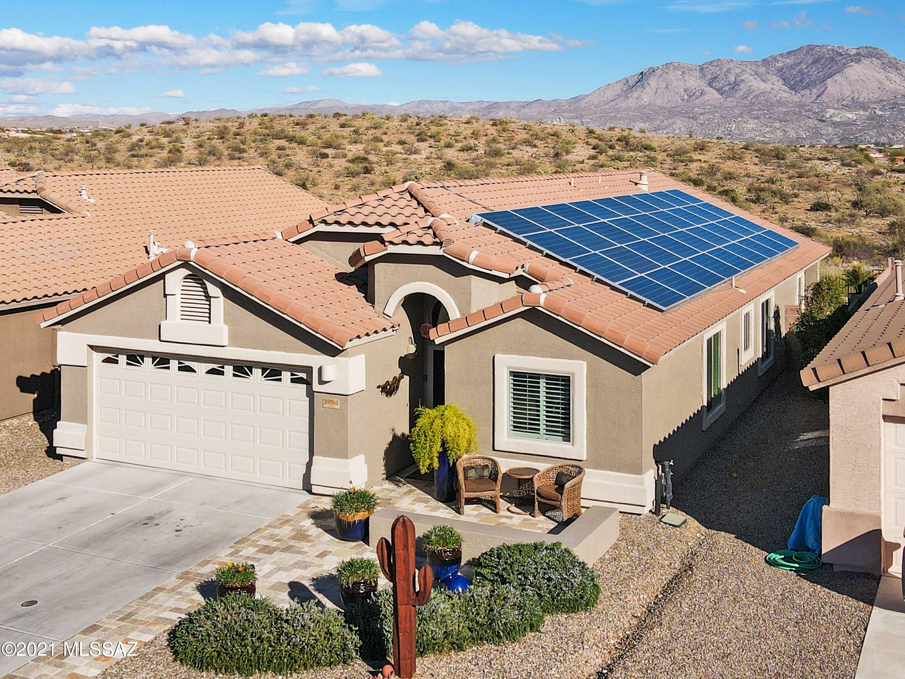 This gorgeous home is move in ready, located in the highly desirable Eagle Crest Ranch Community. Spend outdoors cooking in your designer rammed earth adobe built-in kitchen. Enjoy the spectacular mountain views of the Catalinas, while catching a glimpse of the wildlife in the natural scenic desert. This one owner home boasts a gas fireplace in the family room, new vinyl plank flooring in the living room, & bedrooms. The kitchen has 42 inch cabinets, pull out drawers, granite countertops, new garbage disposal,  new dishwasher to be installed Feb. 2nd. Plantation shutters throughout, water softener & reverse osmosis. Extended Garage &  newer insulation has been installed. Bose speakers wired in family room, master bedroom & back patio. Newer patio door & three windows installed by Anderson Solar panels are leased and there is no electric bill.