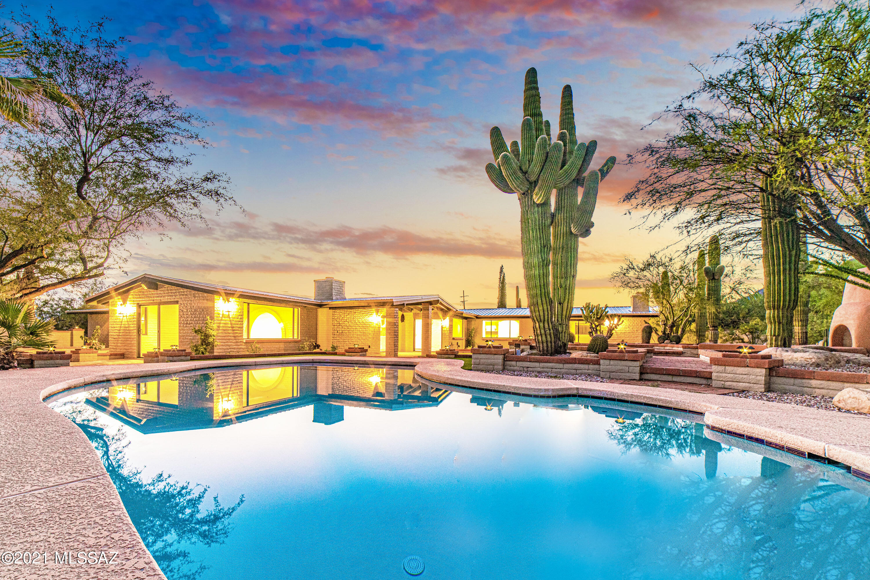 Exquisite and Modern meets the Charm of Foothills Tradition. This magnificent estate has been masterfully refinished with no expense spared! The home has been draped with designer finishes that transport you into modern luxury while tastefully paying homage to the 1971 solid slump block build that brings the Catalina Foothills to life! This fully renovated 5bed/4bath/3car garage offers 3,270sqft of premium living space, dual master suites, 3 fireplaces, and custom outdoor built-in chiminea. A tiered backyard gives way to breathtaking views of the Catalina Foothills. A glance at the extensive list of tastefully considered upgrades and finishes will leave you speechless: Brand New: metal roof, concrete floors, HVAC, raised ceilings, LED lighting...the list goes on! Welcome to the Foothills!