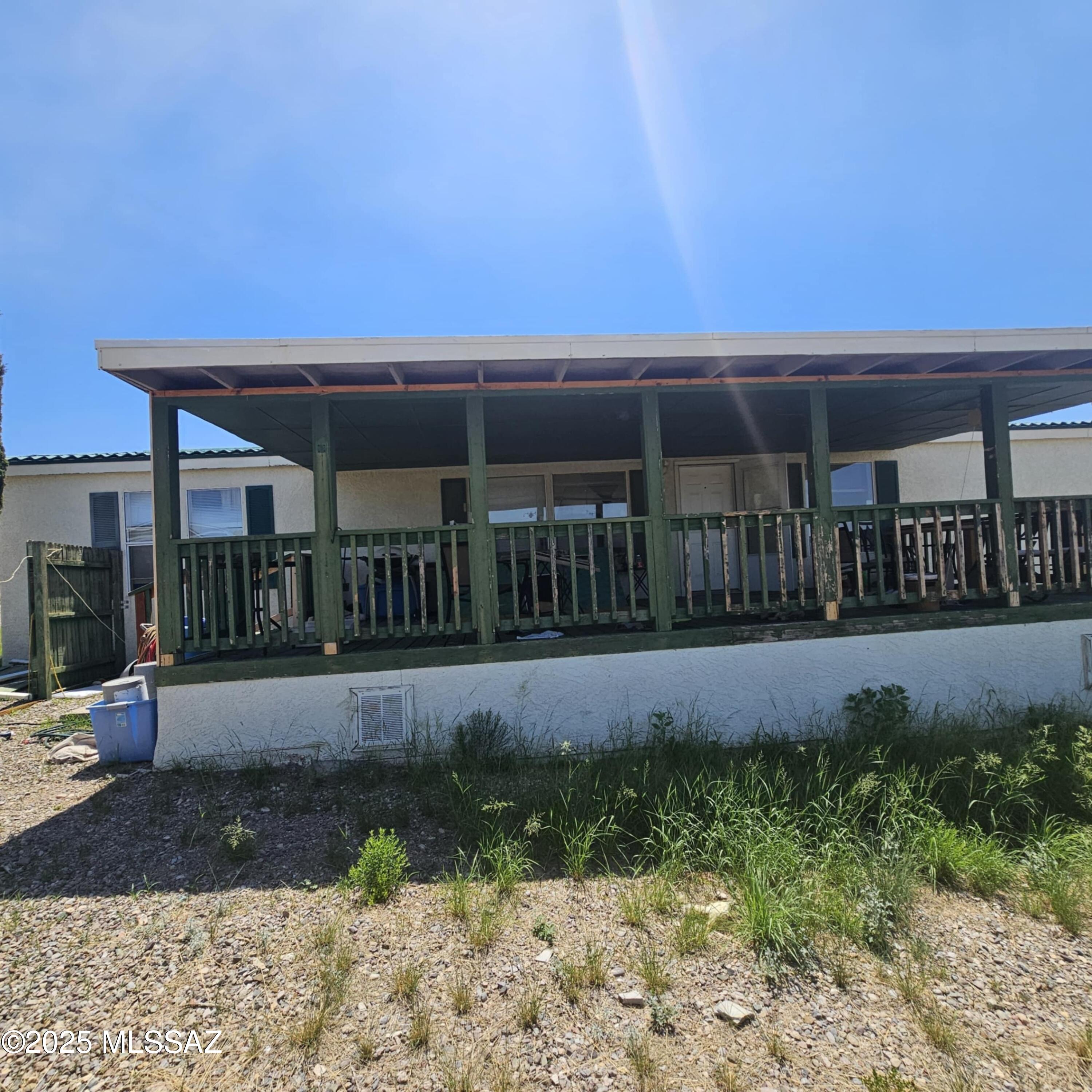 Nestled on a hill with stunning views in Historic Tombstone, this 4-bedroom, 2-bath manufactured home is currently undergoing a full remodel. Due to an insurance claim, a longer escrow period will be needed to allow completion of the renovations. The exterior features a stucco finish and a durable tile-style metal roof, complemented by attractive landscaping and fencing. Covered parking is available for your car, along with a concrete pad perfect for parking a recreational vehicle.