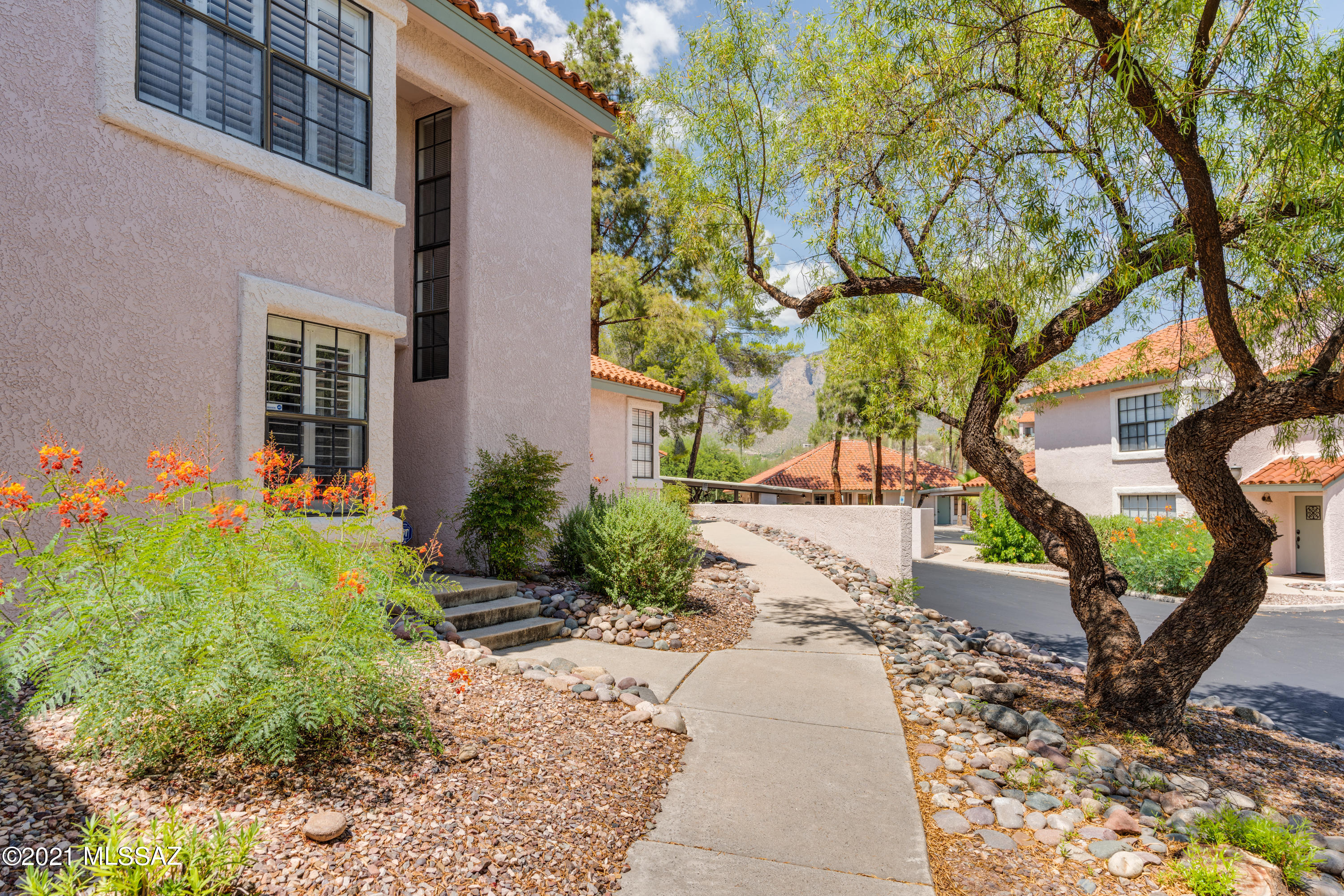 Magnificent well-maintained move-in ready condominium in the Foothills! You'll find lots of designer touches like the shutters on the windows, the archtechtural features, the designer counter tops, recessed lighting  & more The kitchen features gorgeous cabinetry, tile counter tops, stainless steel appliances, breakfast bar & a separate dining area.   The spacious living room has a wood burning fireplace & opens up to a private patio.  Downstairs there's also 1 bedroom & full bath.  Upstairs is a spacious master suite including a walk-in closet, extra cabinets in the bathroom for storage, a sit-down make-up vanity.   
Beautiful community with stunning pool/spa area with exsquite mountain views!  Location is fabulous! Close to La Encantada mall, shopping, restaurants, & more!