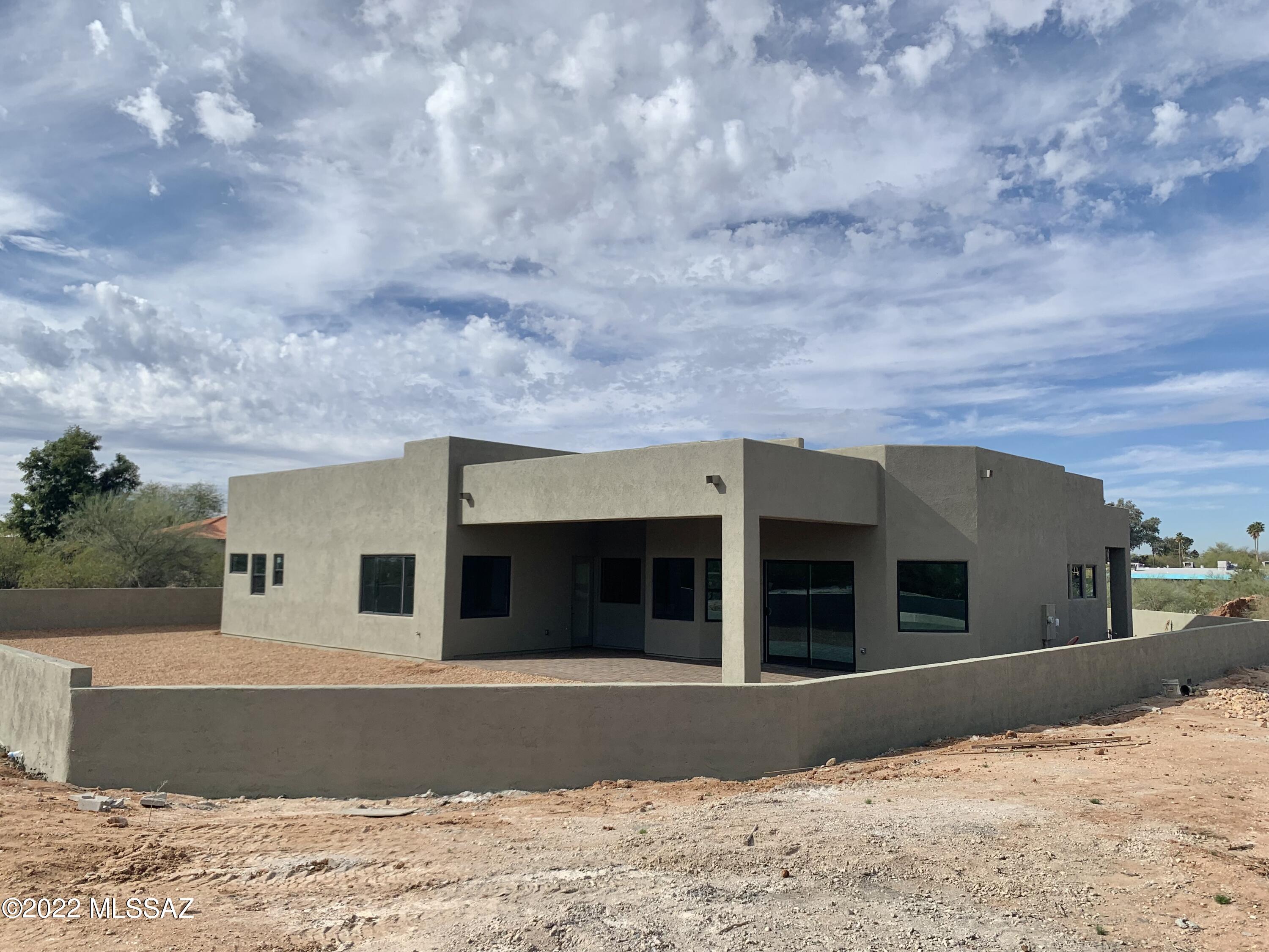 Located in the heart of Tucson, this new construction home is in the historic Indian House Community on .64 acres and privately gated. Views of the desert and mountains are enjoyed from this custom home. Chefs dream kitchen complete with huge island, stainless steel appliances, walk-in pantry, gorgeous cabinets and room to spread out. Luxurious owners suite with 2 walk-in closets & dual vanities. Stunning finishes, custom-made front door/hand carved double barn doors/floating vanity/hardware, counter tops finished in quartz, leather granite and quartzite, inviting great room, oversized bdrms, large 3 car garage, expansive covered porches (in front and back), inviting front courtyard with custom gate, long paver driveway, enclosed backyard and beautiful light fixtures throughout.