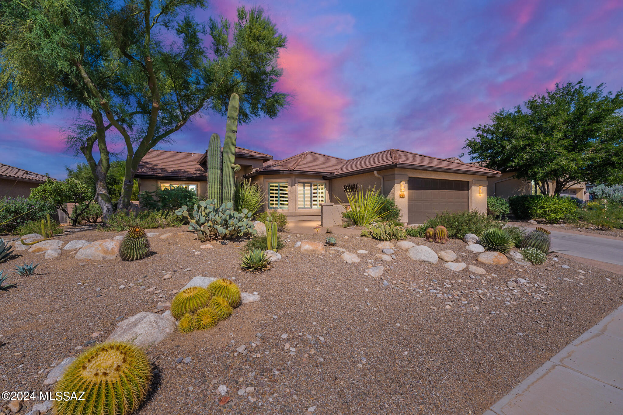Outstanding and VERY well taken care of the expanded Laredo Model in the coveted gated community of Quail Creek!!  Home backs up to a private greenbelt; enjoy the Sonoran Desert birds as they serenate you throughout the day.  The kitchen features Sile stone countertops and stainless steel appliances. Enjoy your morning coffee in the expanded bay window adorned with beautiful shutters.  The primary suite features gorgeous stained concrete with sliding door access to your back patio. The second bedroom has been extended, and a Murphy bed and built-in desk have been added, along with sliding door access to your back patio. Solar is owned for energy efficiency. Amenities for 55+ Living at Quail Creek: "The luxurious Madera Clubhouse, Anza Athletic Club, Pickleball Complex, and Creative Arts & Technology Center are just a few of the amenities for 55+ living at Quail Creek. Learn more about this upscale Arizona retirement community in Green Valley, where you can wake up with nothing to do or everything to do."