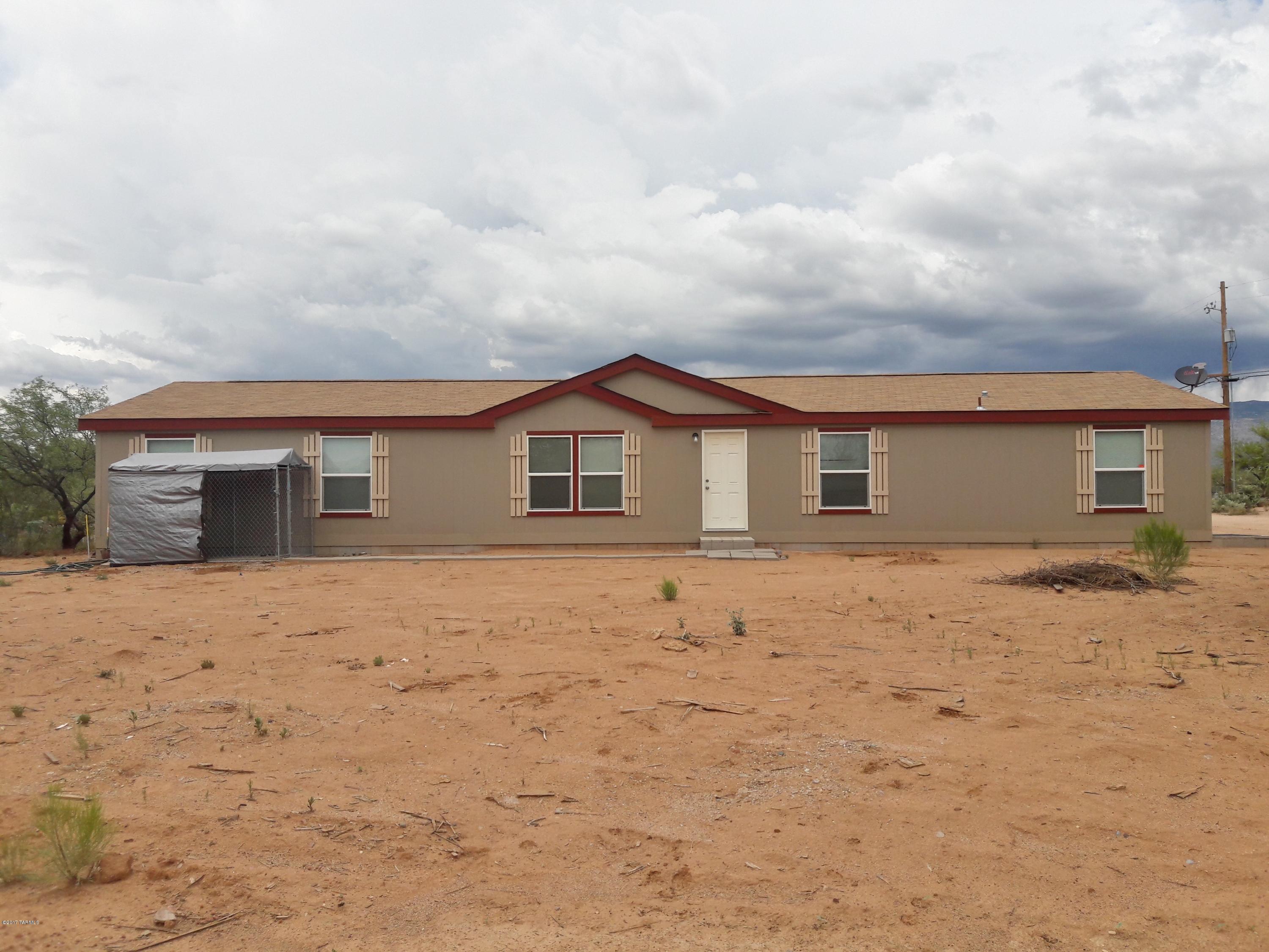 This almost new MFH is on a flat corner with unbelievable mountain views. This
property is a fenced acre with a clean slate for horse or livestock stables or arenas, a large work shop, or what ever your
needs may be. This large home is a great family home with a large living room, family room, and a kitchen that is open to
both. This home is on the Kahlua well share located in the award winning Vail school district. The higher elevation means
cooler days in the Arizona sun. Great mature mesquite trees on the property with no HOA to limit your lifestyle. So come live the country life but not far from everyday needs!