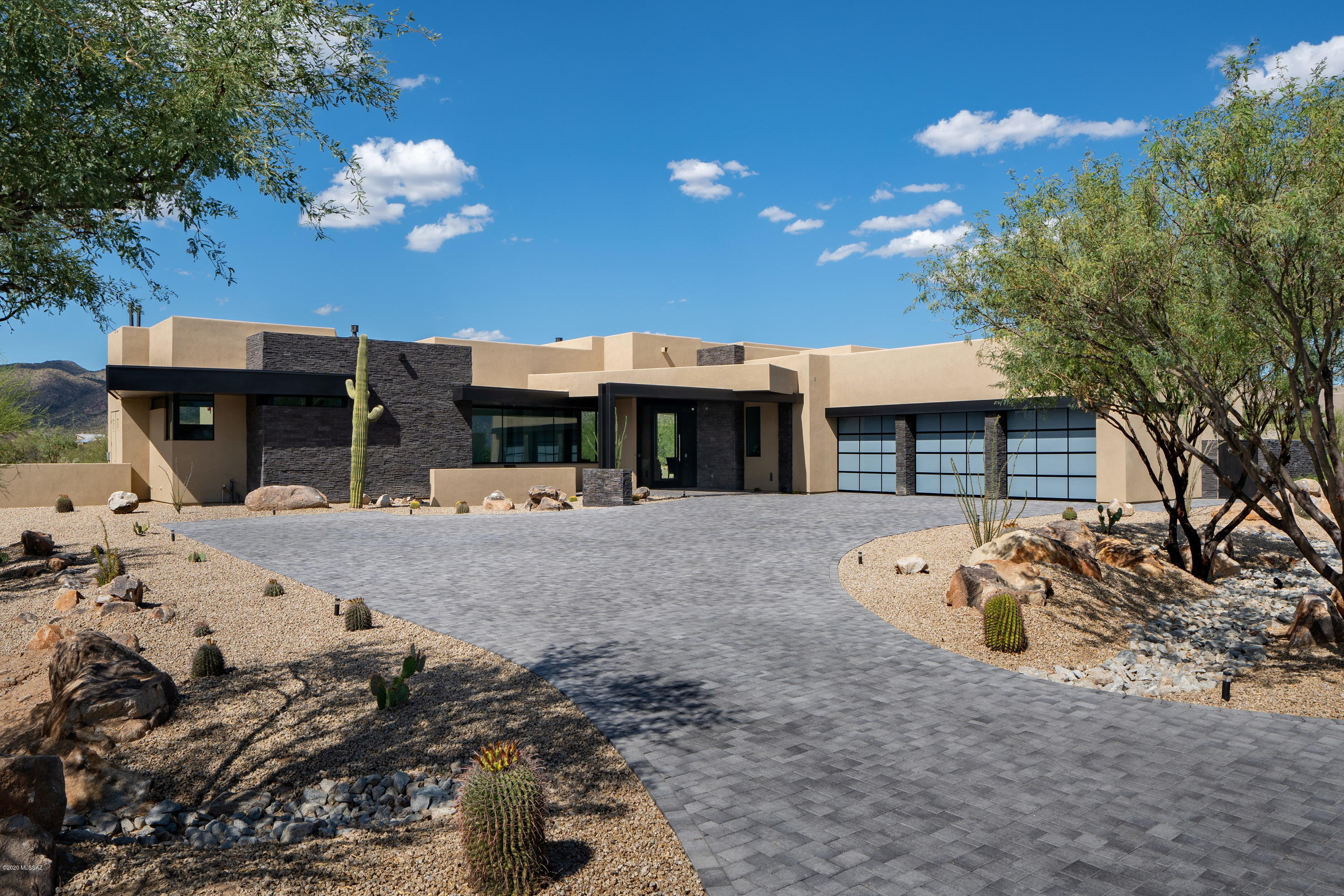 Stunning contemporary architecture designed by Marc Soloway. Located on .76 acres in the exclusive guard gated Stone Canyon golf community. This contemporary open floor plan is complete and has 4 bedrooms and 3.5 baths. The 3639 square feet have been thoughtfully laid out to maximize the surroundings. Step out onto the backyard and take in the beautiful unobstructed Tortolita Mountains. Stone Canyon HOA owns 20+ acres behind the property so your view will never be compromised.  Renderings of a pool are in the photos and can be built in a very short time for your outdoor enjoyment.