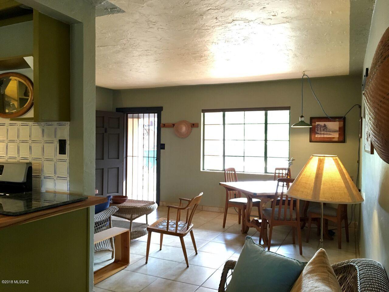 2 1/2 bedroom house, plus casita. Combination of modern efficiency, vintage charm, and unique authenticity rarely found at this price;in a convenient but quiet location. From this quiet one-block st. tucked behind a large church, walk to Botanical Gardens and Franks, each one block away. Ride a bike 5min to library, 8min to Loft Cinema/WholeFoods, and 15min to UofA. Newly updated with craft and conservation in mind; not another big-box remodel - kitchen counter of teak butcher block and vintage handmade Japanese tiles, original wood cabinets with true Bakelite handles, embossed tin backsplash with hand-painted delft blue details, and APEC fitered water at the tap; new high efficiency appliances including EnergyStar rated ceiling fans, European Bosch fridge, Samsung water-saving dishwasher, Maytag Bravos XL gas dryer, LG HE front load washer, and Bradford White Defender-Saver gas water heater. All new low=VOC paint job, central air conditioning, $5k new Hunter Douglas insulating blinds, small but serviceable bathroom, Sentricon green termite inspection and service monthly since Sept 2017. Covered carport and wrap-around patio. The roof/eaves will need updating within a couple yrs. Fresh roofing bids $8-$10 available for calculations. No leaks. Casita features modern retrofit genuine antique iron farmhouse sink with custom redwood base, designer low-water/dual flush toilet and lavatory console sink, plus new Friedrich air conditioner. An ideal rental or work studio. Big yard with fire pit and mature trees including fruiting grapefruit , lime and a native velvet mesquite with sweet flour beans. New garden beds. Front yard sown with Sonoran revegetation mix, backyard with birds/bees/butterfliers xeriscape mix. This is an urban birdwatching getaway with varied species, including multiple pairs birds of prey in registered habitat eucalyptus next door.