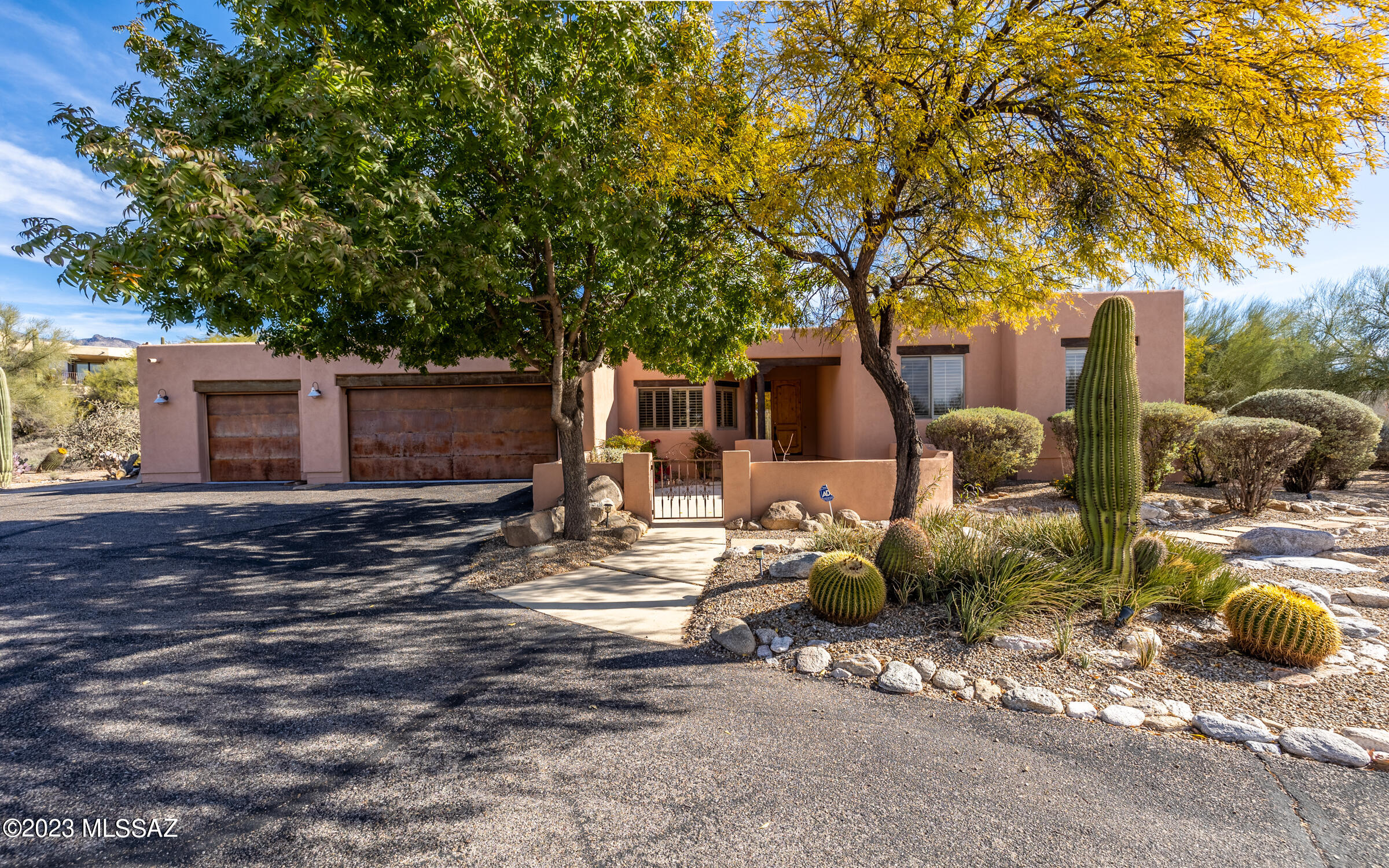 This 4 bed/3 bath southwest beauty is nestled in the highly desirable Catalina Foothills on 1.42 acre lot, surrounded by desert views! The home is absolutely turnkey, built in 2001 at over 3000sf, w/soaring ceilings, gorgeous concrete floors, 3-car garage w/rustic doors, professionally landscaped grounds surround the home & a freshly painted exterior! Gated front courtyard w/covered patio & beautiful wooden lentils above the windows add to the custom feel. Wood posts welcome you from the courtyard & continue into the interior where you are greeted w/rear views of the pool, a saguaro studded hillside, & two beehive fireplaces. The formal living/dining, great room, & the owner's suite ALL have walk-outs to the rear yard under two expansive patios! Voluntary HOA. SEE Upgrade List & VIDEO!!