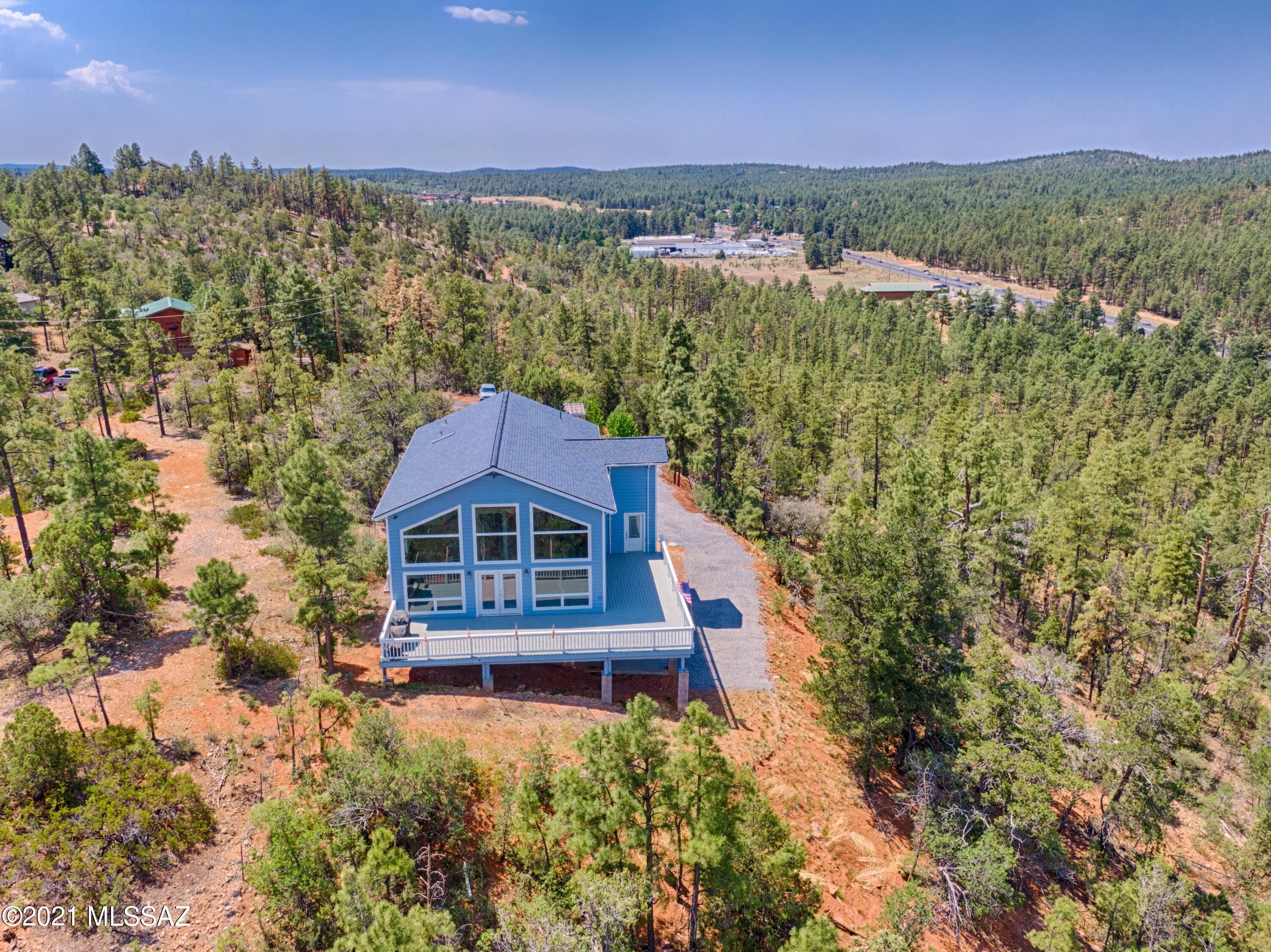 Gorgeous and unique home on top of the hill with fantastic views!3 bedroom, 2.75 bath home is on 2.5 acres that is heavily treed providing lots of privacy at the end of a short road. The large primary bedroom and bath with an office are on the upstairs loft.  Main level is an open floor plan with kitchen, living room, bedroom, bath , laundry and foyer/mud room. Walk out Basement is another bedroom, kitchen and 3/4 bath. over sized finished 2 car garage. Many upgrades include granite counter tops, self closing cabinets, double oven, electric gate.  There is a green house and 2 apple and 1 pear tree.
Be sure to come see this beautiful home with phenomenal views!