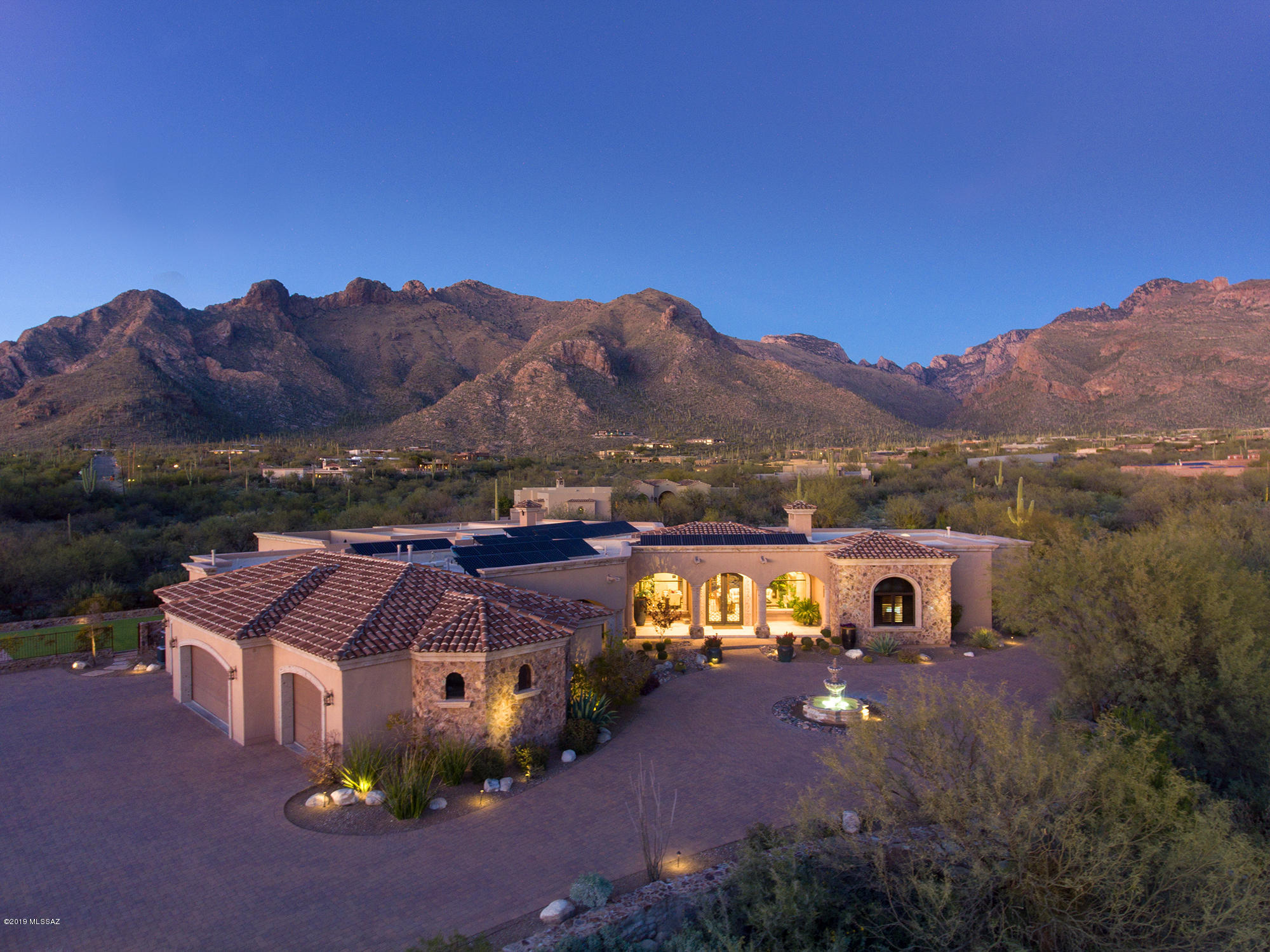 Owner/Agent. Masterful design & luxury are embodied in this distinctive 7150 sqft, 4 BR, 7 BA, 2.66ac. villa. This one of a kind home, created by Christian Dixon is nestled deep in the foothills w/stunning city & unobstructed mountain views. Every detail carefully selected & quality crafted. A divine master suite presents massive windows, fireplace, opulent en suite bath & exercise room.  Automatic sliding doors in the living/dining area showcase awe inspiring views of Pima Canyon and the spa style pool with relaxing water features. Other highlights include natural stone floors, hand carved cantera and wood accents throughout, whole home automation, high tech security system, whole home water filtration and softener, fully appointed media and rec rooms, study w/en suite & Murphy bed, top of the line chef's kitchen and the list goes on! Green features include solar system, electric car charging station and Rasta Block for superior insulation.