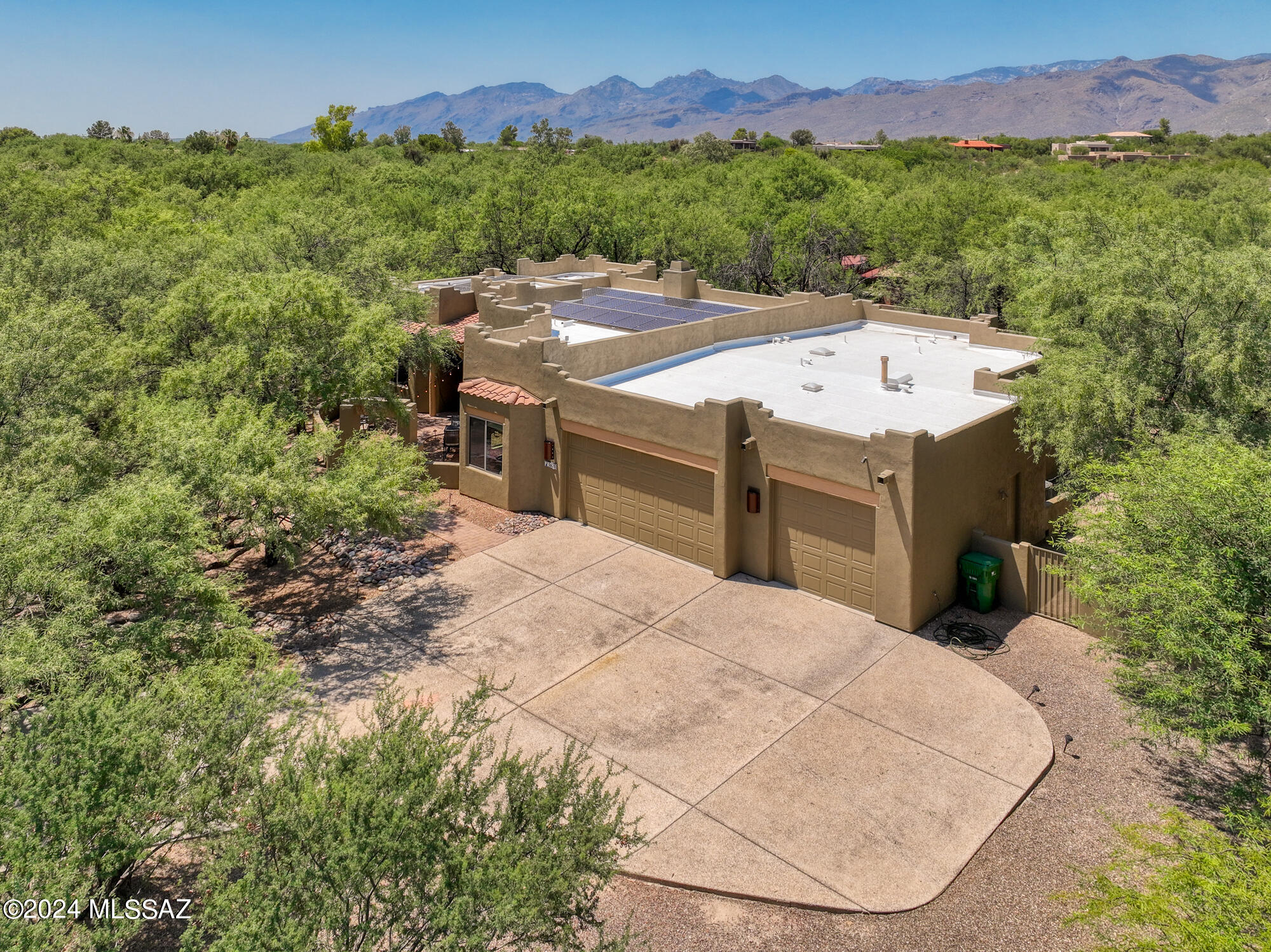 Discover the charm and tranquility of this private 5-bedroom, 3-bathroom home, nestled on over a half-acre of serene mesquite bosque in the sought-after Northeast community of 49ers Country Club Estates, Tucson, Arizona. Soaring Ceilings throughout! No steps! 
This one-story property is close to the 49ers Country Club golf course. Enjoy the natural beauty of a picturesque mesquite grove where you can observe local wildlife, including adorable baby javelinas.
The home features a newly installed, paid-for solar array, resulting zero electric bills for the owner. It offers North/South exposure, a charming courtyard entry, and a low-maintenance backyard with synthetic grass, a covered patio, and a newer hot tub for ultimate relaxation. The large eat-in kitchen is a chef's dream!