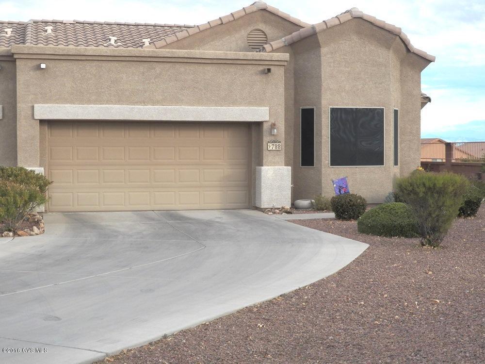 Beautifully upgraded 2BR 2BA townhome with great attention given to the smallest detail. Notice the custom mosaic design in the tile floors, inlaid at key entry points throughout the home. The tile floors compliment the tile kitchen counters, breakfast bar and backsplash. Sit in the great room or in the back patio and enjoy awesome mountain views. The great room concept, high ceilings and 3 bay windows, enhance the interior's sq. footage. The 2nd BR has maximum functionality with the installation of a gorgeous knotty alder 21 deep wallbed with shelves, drawers and matching desk. The kitchen features new appliances, oak cabinets, roll-out shelves, undercabinet hard wired lighting, coiffered ceiling with light/ceiling fan combo. The interior was painted in 2015. See a lower electric  bill due to increased insulation throughout the attic. Corner location provides great privacy, panoramic mtn views, extra long driveway for RV parking. Some less obvious extras are electronic air filter, new water heater, walk-in closets in both BRs, solar screens, multiple storage cabinets, LED energy saver lights, solar exhaust fan in the attic.