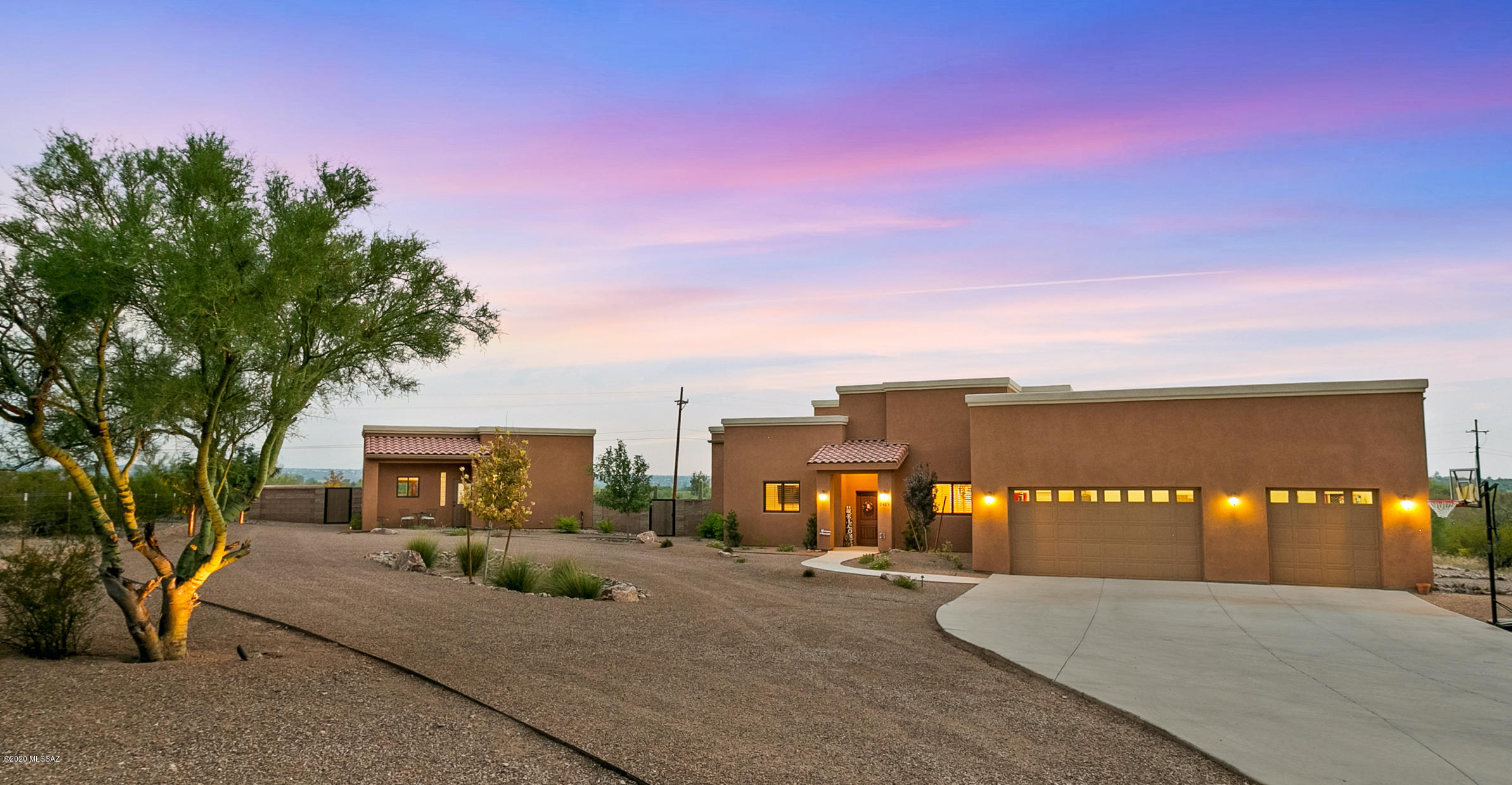This newly constructed residence is nested on 3.3+ acres behind a private gated drive shared by only one other home. Serene desert surroundings compliment low maintenance-designed patios and entertainment areas. With 5 bedrooms and 3 baths, the home welcomes family and friends. A substantial brick fireplace in the living room warms the space while a well-appointed contemporary kitchen serves as a focal point or hub for the residence. There's a 1 bd 1 bath guest house. 3 car garage. And a 38'+ X 22'+ RV garage. The private well set-up includes a Water Tec Filtration system and has a 5,000 gallon holding capacity.