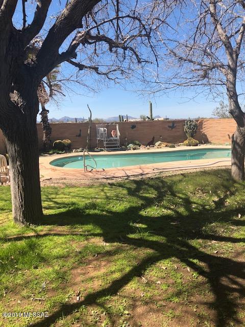This charming 4 bedroom/ 2 bath ranchette is on 3.3 acres. It is located just minutes from Saguaro National Park. It has no HOA, fabulous views, swimming pool and a detached garage. Plenty of room for RV storage or horse facilities.