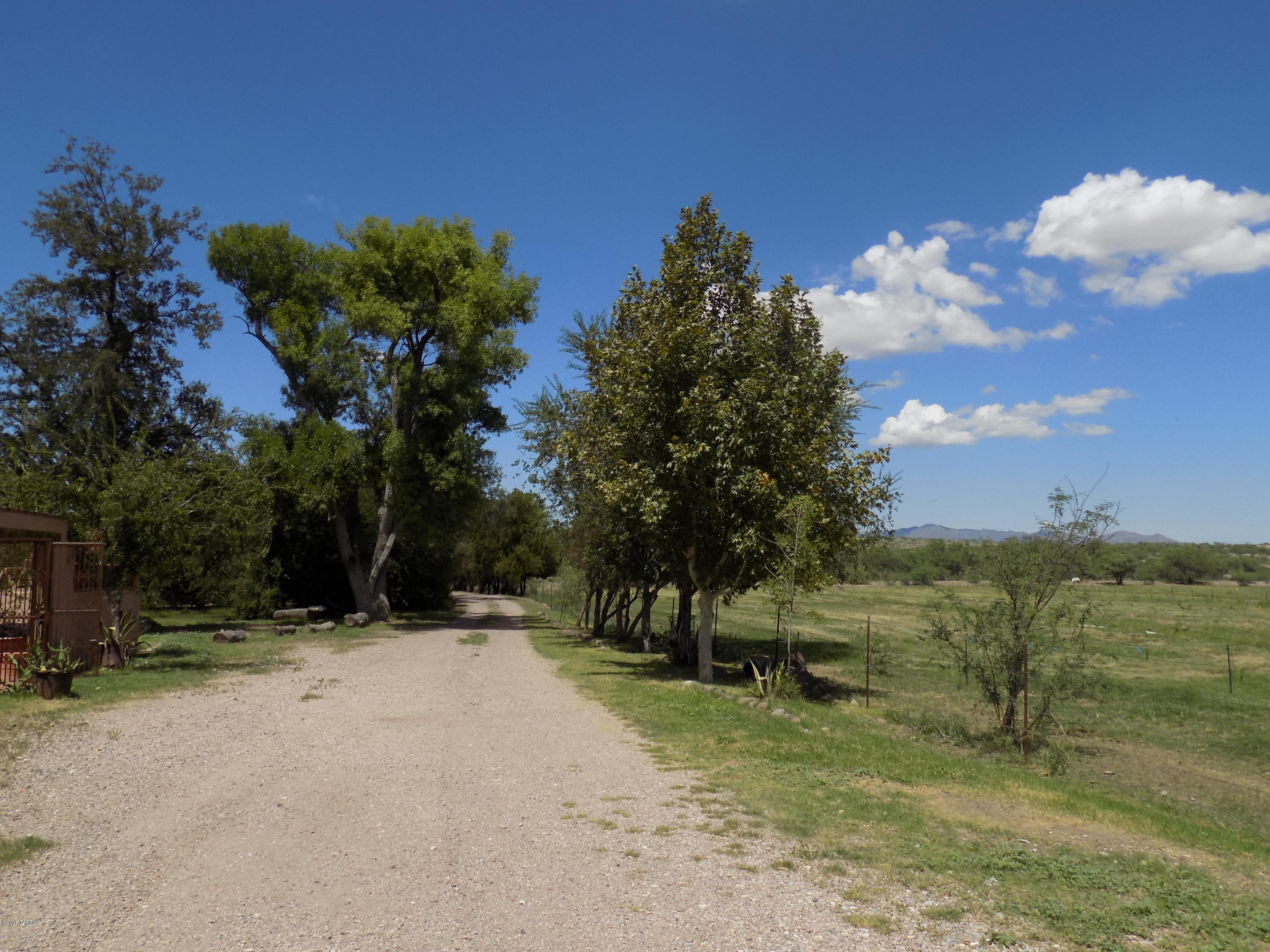 Beautiful and historic farm. Access is only approx. 10 miles from freeway on Arivaca Rd. Property has approx. 47 acres of irrigated water rights. Main house built in 1932, guest house built in 1955. Horse facilities, dog run, lovely green house. Fabulous mountain views. Great riding opportunities on adjacent county land.
