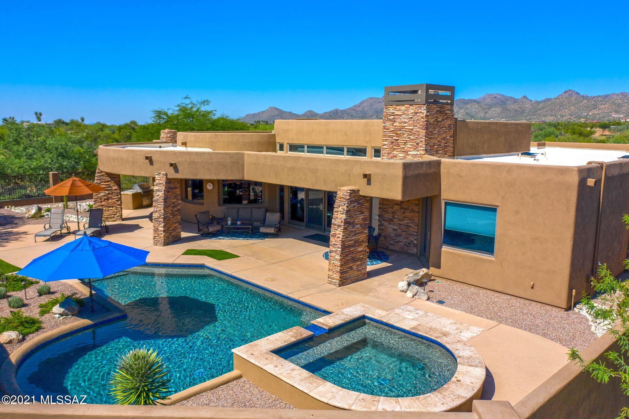 Think ''picturesque'' and what comes to mind? This beautiful hidden gem, bathed in Modern Soft Contemporary Architecture designed by Kevin Howard provides an exclusive lifestyle in the private guard gated golf community designed by Jay Morrish in Stone Canyon. Exquisite drive at the end of a cul-de-sac on a 2.12 acre estate designed with an open great room plan that opens to breathtaking views, makes a bold statement in contrast to the rugged, picturesque mountain views, boulders, and Stone Canyon resort lifestyle. The expansive windows clearly bridge the ethereal gap between the breathtaking views of the majestic Pusch Ridge Mountain views and the lifestyle you embrace, inside. This home was completely remodeled and brought to life by current owners. This contemporary 2,866 square-foot home is comprised of 3 bedrooms, dining with radius view window, 2.5 baths, 2 Fireplaces (great room & patio), gated courtyard with custom iron gate and entry door, Oversized 2-Car Garage. Custom features: textured porcelain floors, interior wood doors, Gourmet kitchen boasts Miele SS appliances, retractable down draft vent and induction cooktop, dishwasher, refrigerator, custom wood cabinets, granite slab with designer tile backsplash. Huge master suite and bath: custom tile & pebble stone shower floor, free standing tub, and walk in shower with several heads, walk-in custom closet. Great room opens directly onto expansive patio, offering desert views, stacked stone fireplace accented with canterra stone. Superior quality, finished Solar heated Pebble-tec pool & spa with spillway, built in stone outdoor custom BBQ. Stone Canyon nestled against the picturesque Tortolita Mountains a private residential golf community boasts a luxurious health & fitness facility and modern restaurant & bar, dining facilities, locker rooms, and social functions and activities.